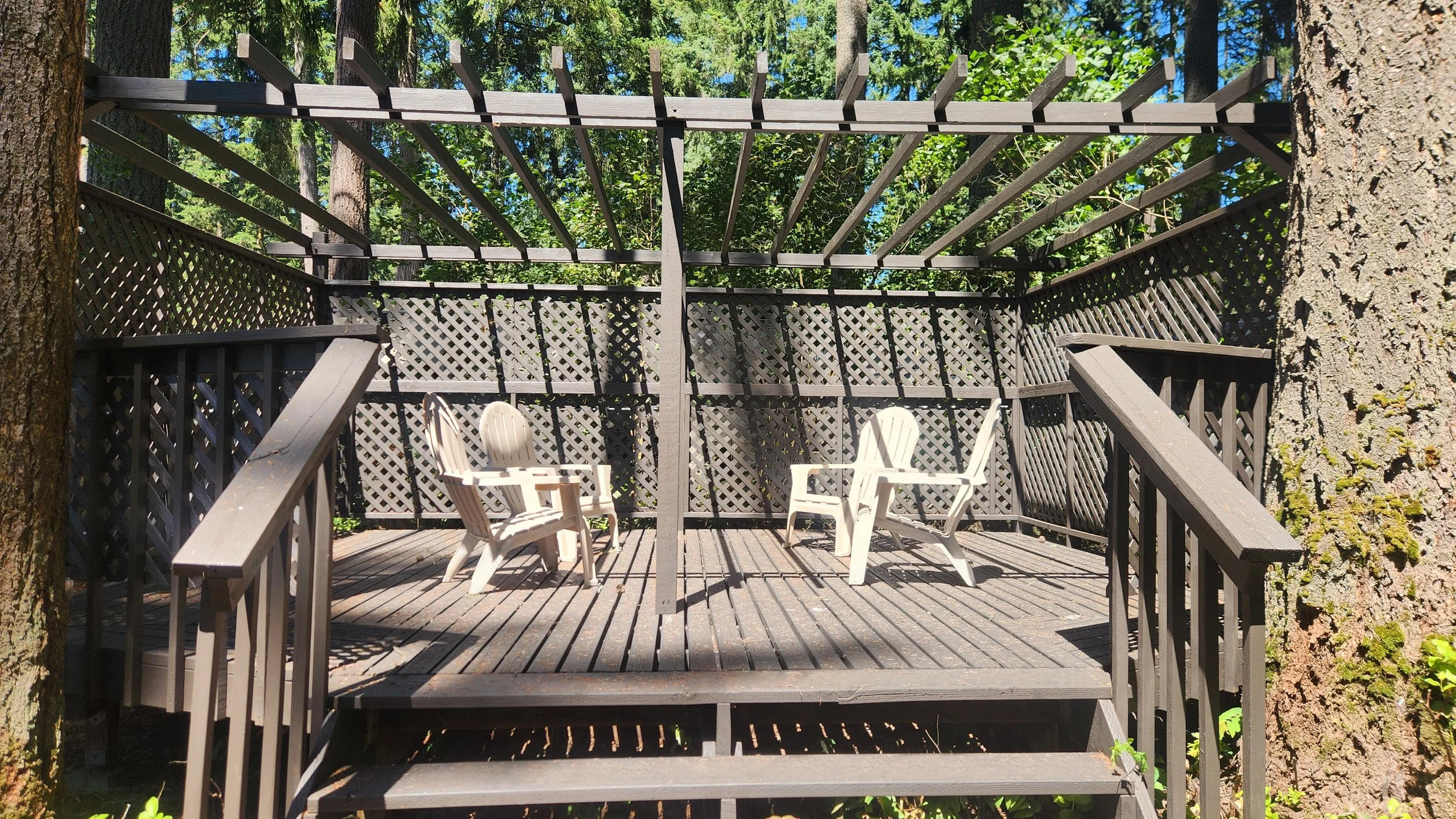 Pergola deck with adirondack chairs