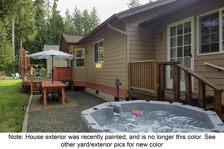Side yard hot tub and patio table, with note that the house exterior has since been repainted