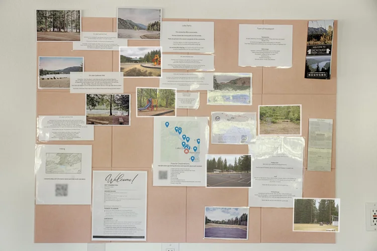 Guest activity board pinned with local park photos, a map and a welcome letter
