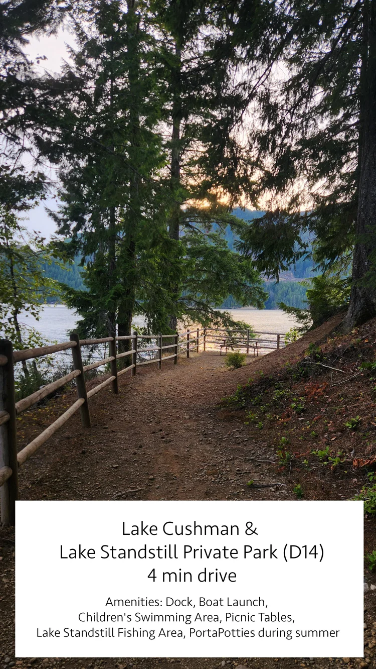 Fenced dirt path through firs to the lake at Lake Cushman and Lake Standstill Private Park D14