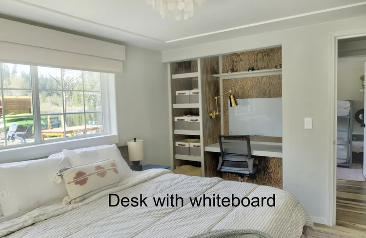 Bedroom with built-in desk, wood-panel shelving and whiteboard, Desk with whiteboard caption