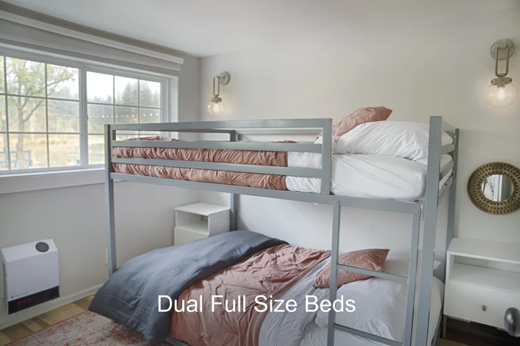 Bunk room with gray metal frame and pink bedding, Dual Full Size Beds caption
