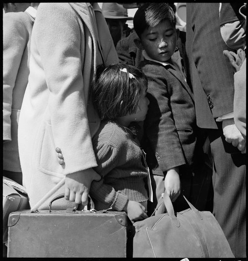 Byron, California. Third Generation of American children of Japanese ancestry in crowd awaiting the arrival of the next bus which will take them from their homes to the assembly center. Central Photographic File of the War Relocation Authority, National Archives.