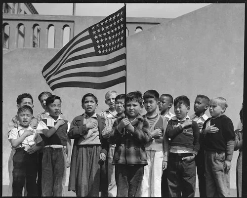 San Francisco, California. Flag of allegiance pledge at Raphael Weill Public School, Geary and Buchanan Streets. Children in Families of Japanese ancestry were evacuated with their parents and will be housed for the duration in War Relocation Authority centers where facilities will be provided for them to continue their education. War Relocation Authority, National Archives.