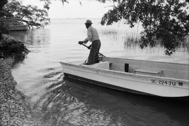 Jake and his Boat Arriving on Daufuskie's Shore , 1978. From Daufuskie Island. Jeanne Moutoussamy-Ashe.