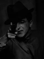 Jean Cocteau with Gun (1926), gelatin silver print (Berenice Abbott Archive, Ryerson Image Centre © Ronald Kurtz, administered by Commerce Graphics Ltd. Inc.)