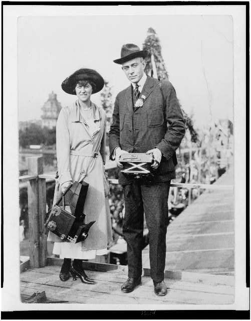 Lucian and Helen Johns Kirtland , full-length portrait, facing front, both holding cameras. Between 1910 and 1920.