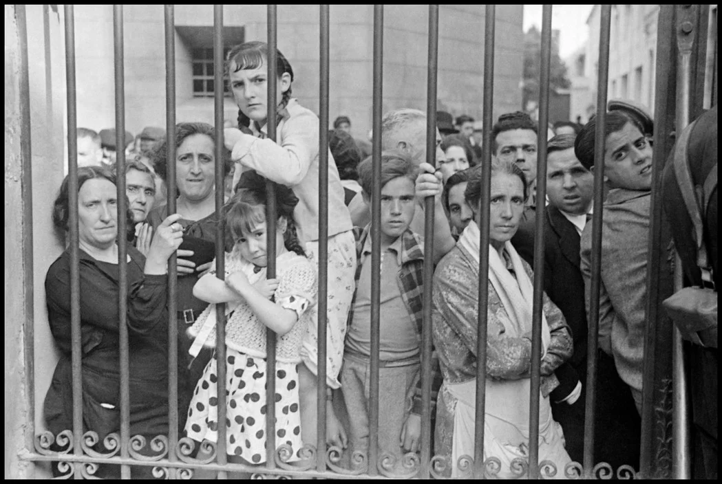 Crowd outside morgue after air raid. May, 1937. Valencia, Spain.