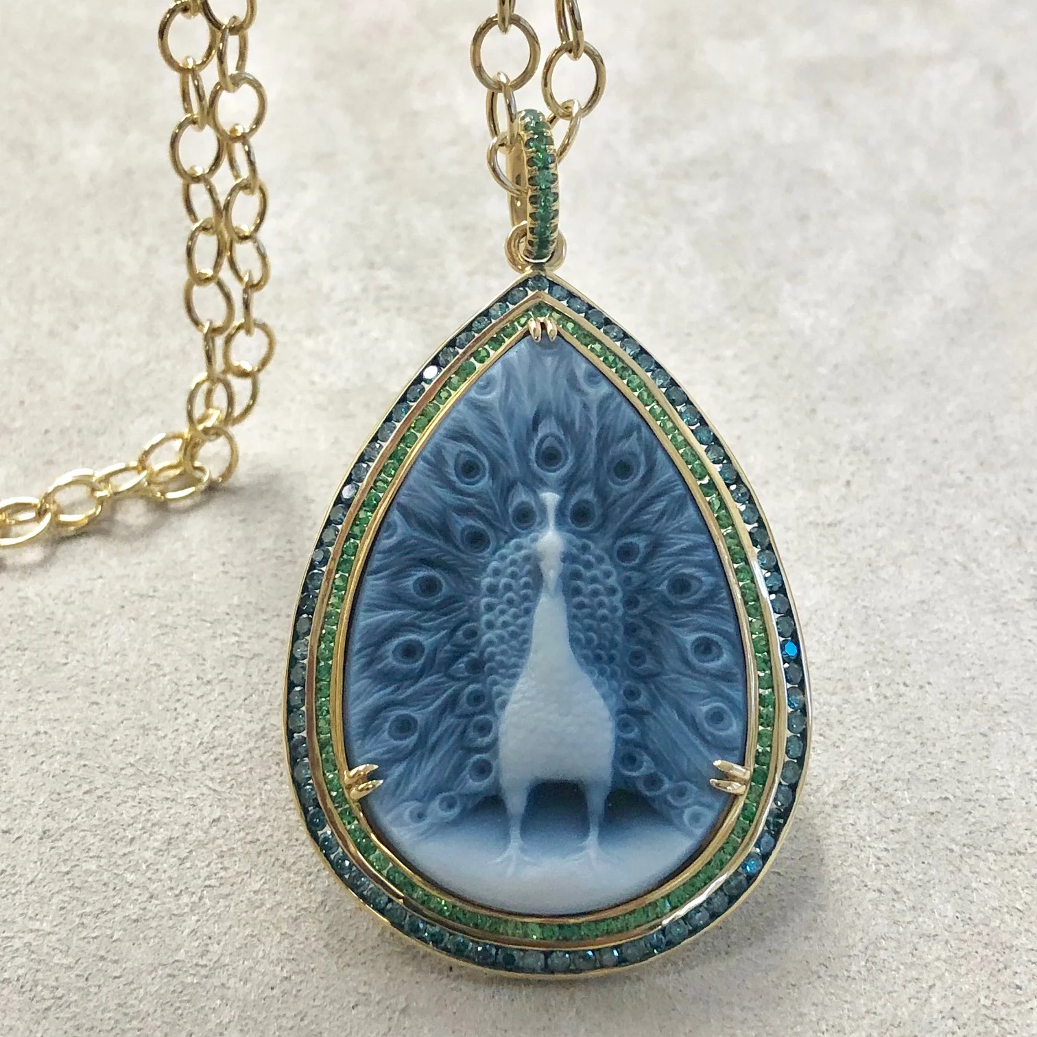 Syna 18 karat yellow gold peacock cameo pendant with tsavorite and blue diamonds
