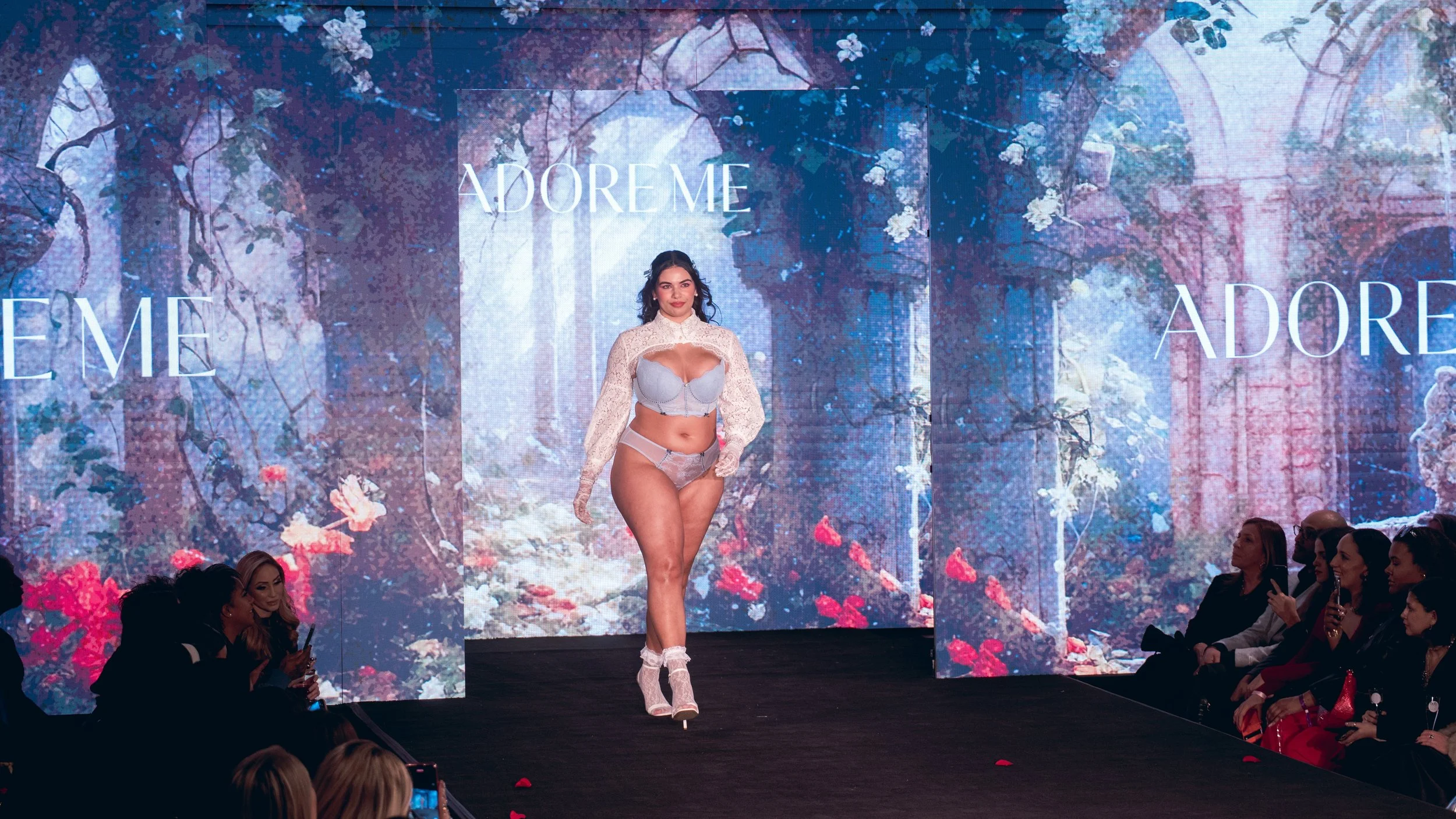 Model in a white two-piece look walks toward the audience on the Adore Me runway at New York Fashion Week 2024