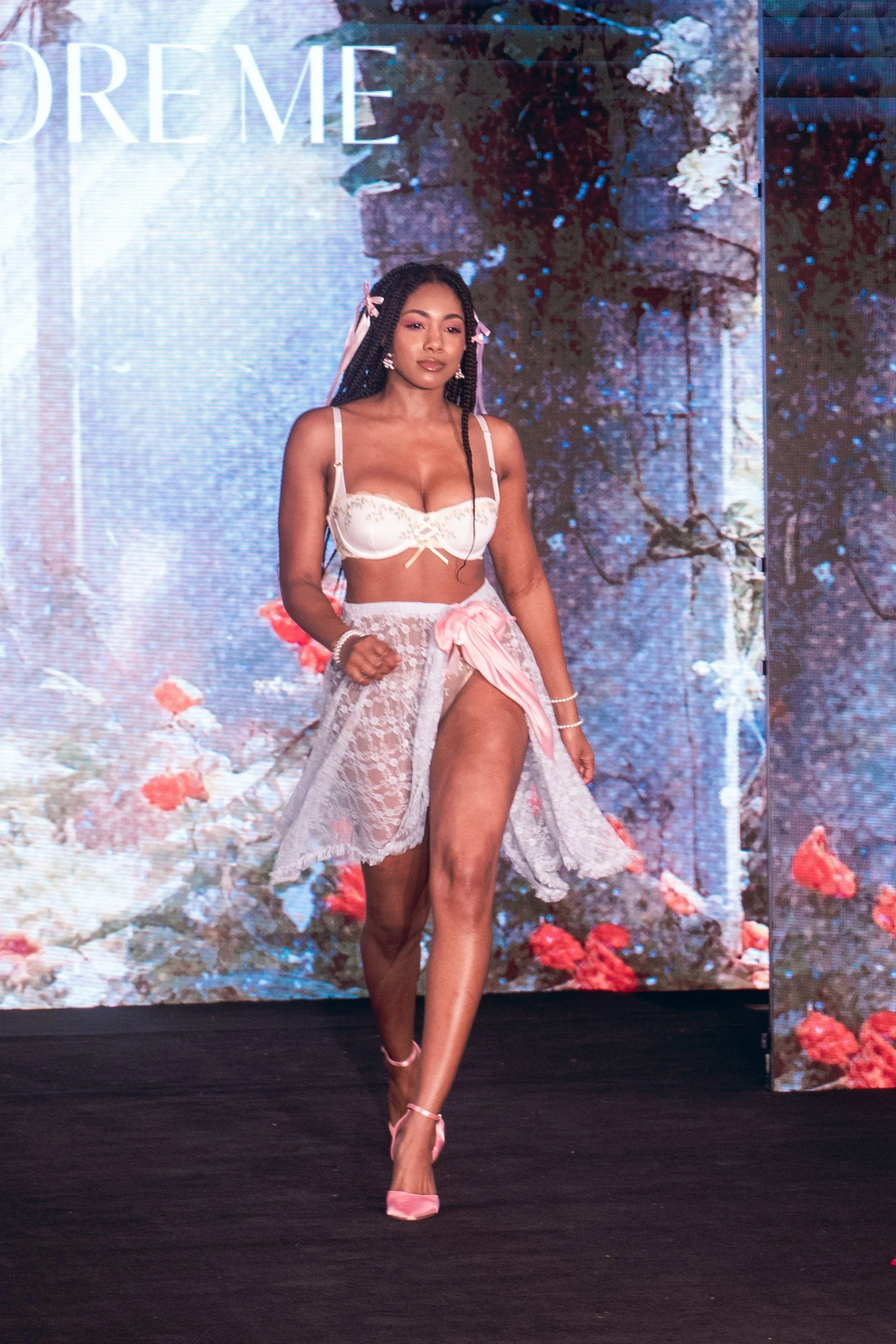 Model in white lingerie and sheer skirt walks the Adore Me runway at New York Fashion Week 2024