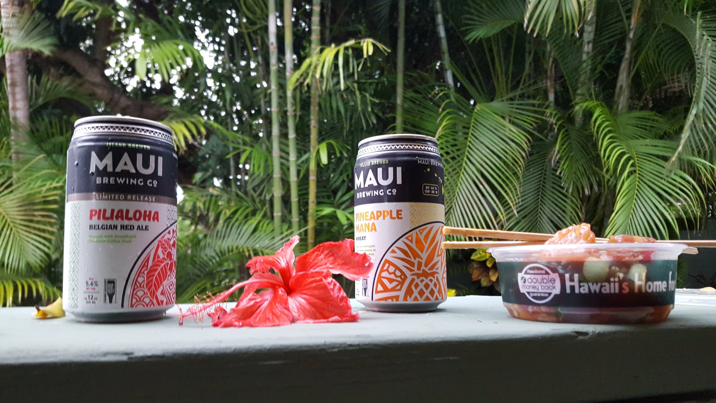 Three essentials: Beer, Poke, and a green, tropical backdrop.