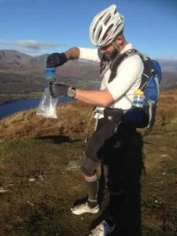 Anthony mixing his homemade energy pack with water he collected from a stream during the MTB