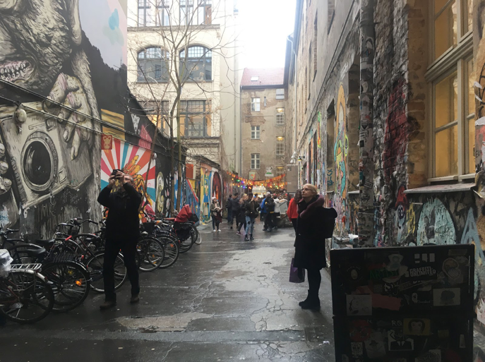 
Berliners and tourists take snapshots in the narrow courtyard of the Haus Schwarzenberg, a longstanding cultural center. The building contains cooperatively run art spaces including a movie theater, galleries, café, and two museums oriented towards the history of the Holocaust. The dilapidation of the brick and stucco facade, and the preservation of the tight and commercially-unappealing courtyard are counterpreservation (CP) techniques. These techniques keep expenses down, and provide a visual and philosophical counterpoint to surrounding buildings that have been restored. Courtesy ofNatasha Tabachnikoff