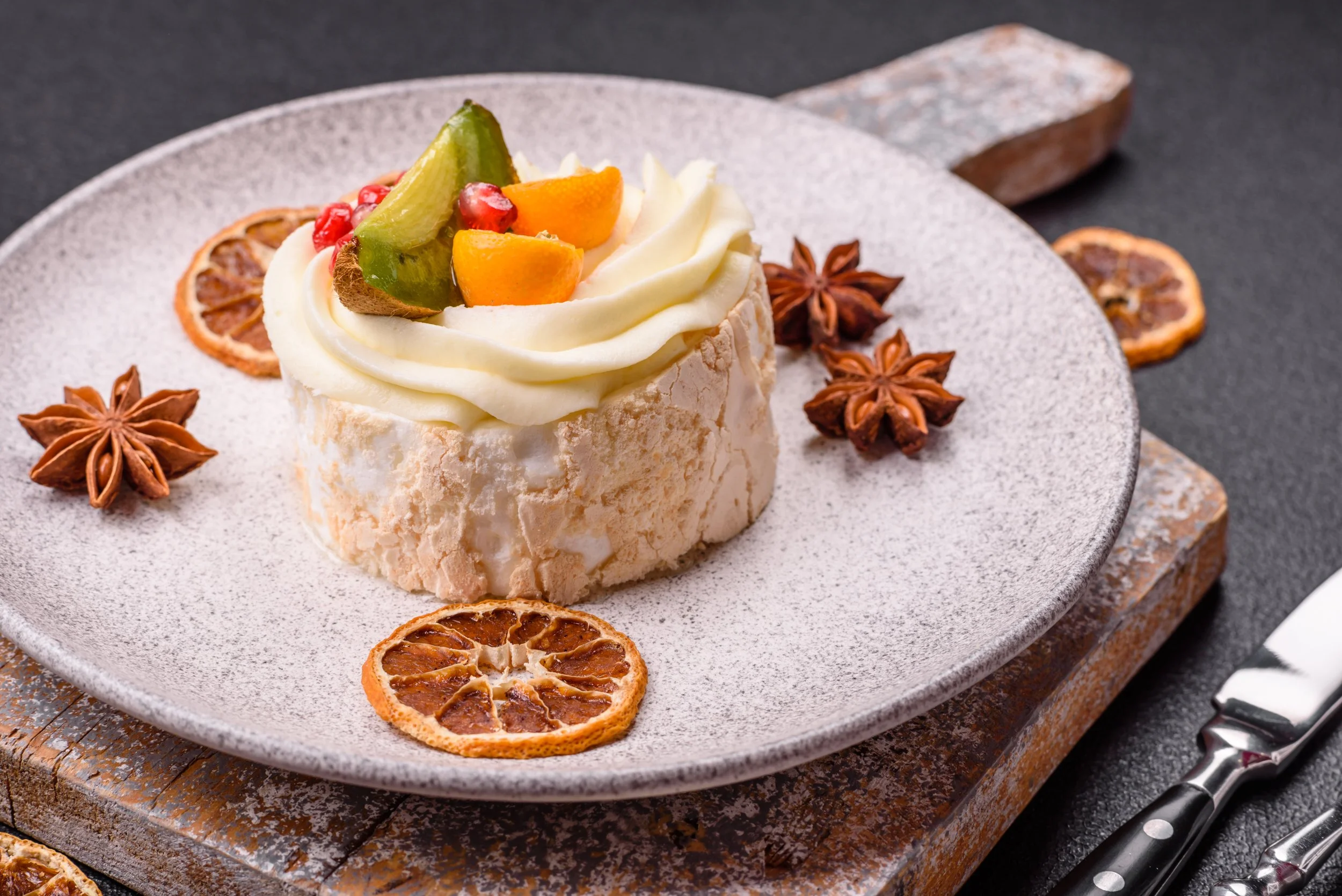 Piece_Of_Sweet_Meringue_With_Citrus__Kiwi_And_Pomegranate_Seeds_original_3018515.jpg