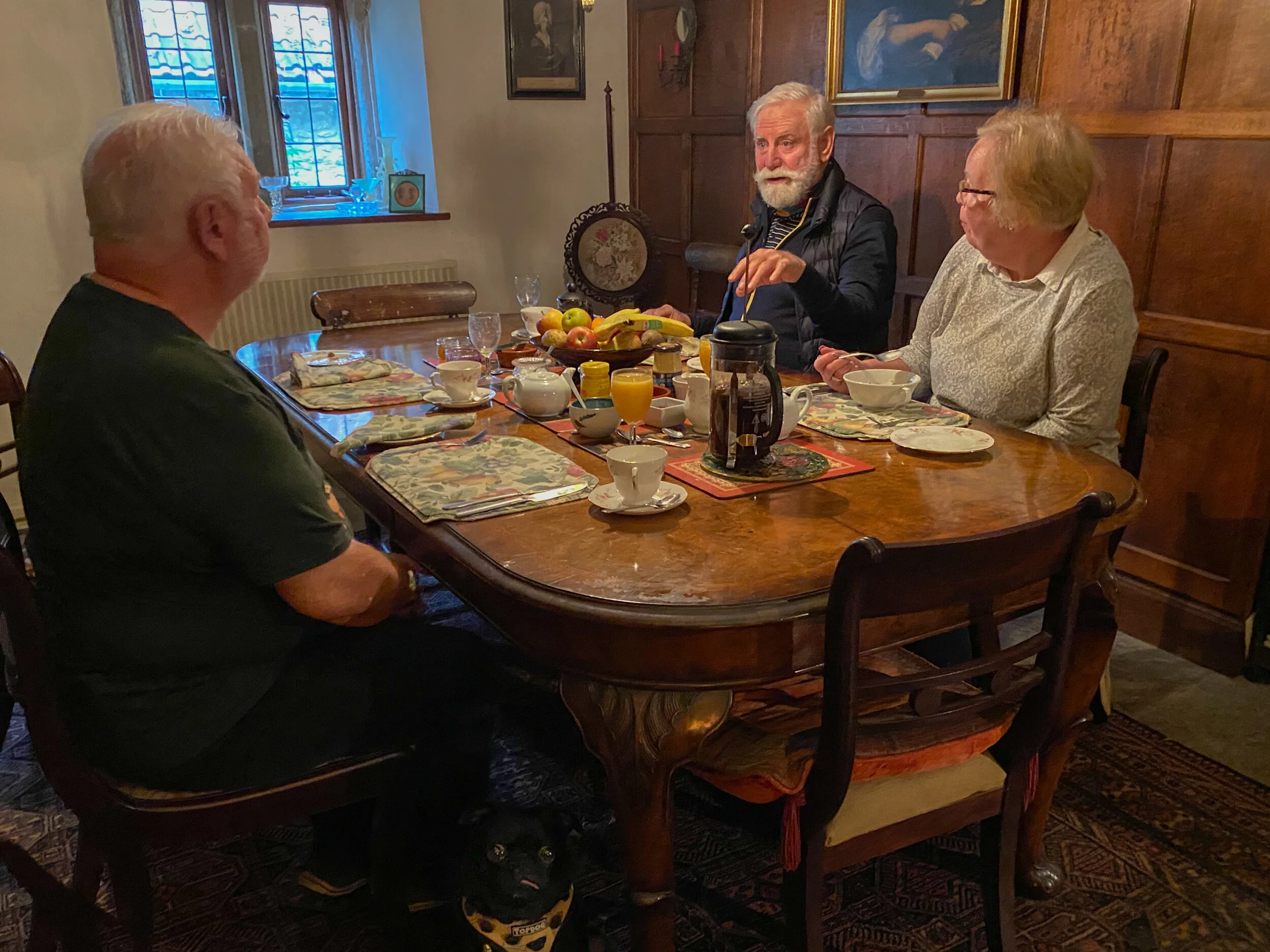 The pug people. Note pug under the table.