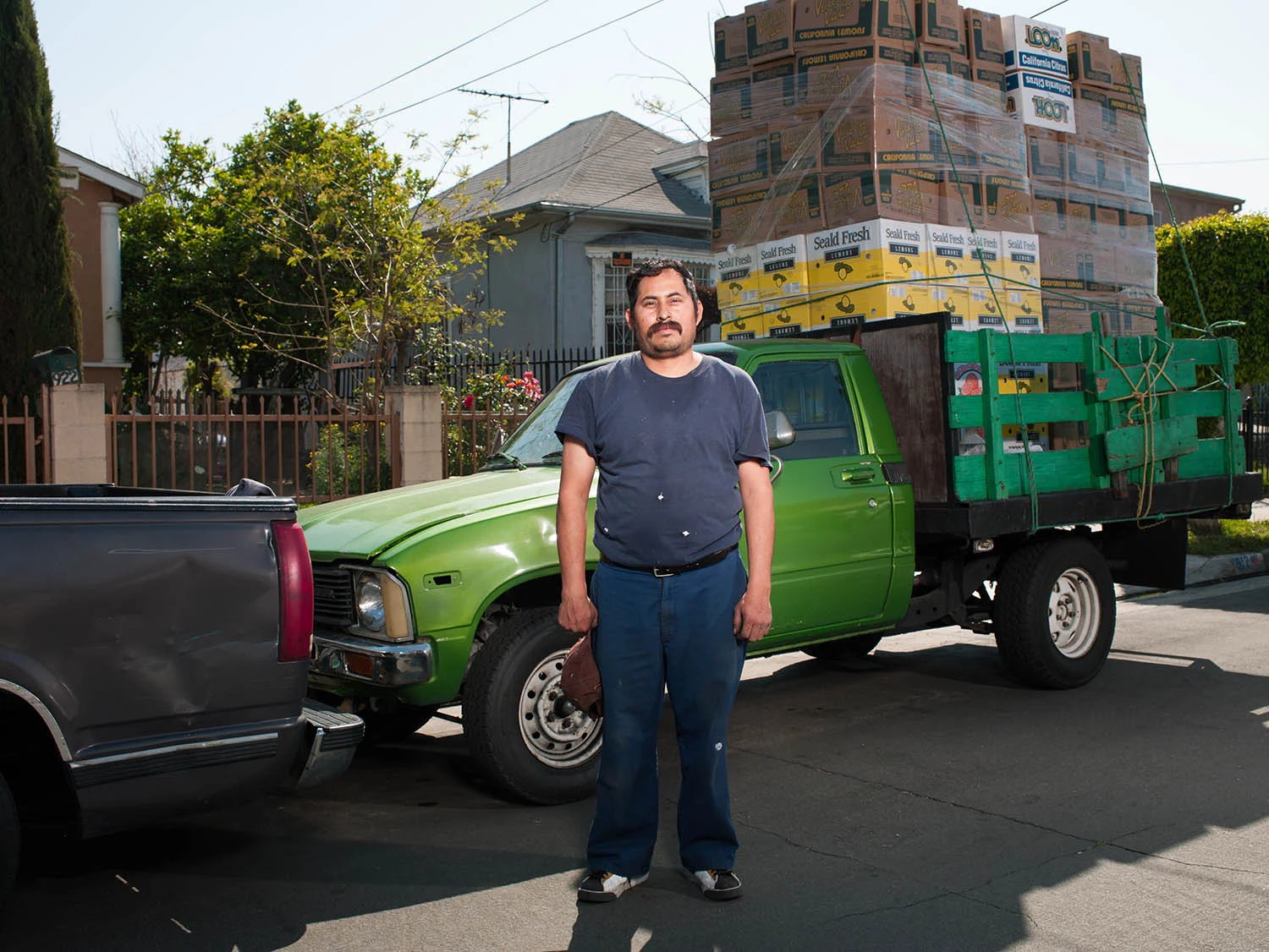 Justino Santos stands with a truckload of new citrus boxes in front of his home on 43rd St and Wadsworth Ave on March 20, 2012.