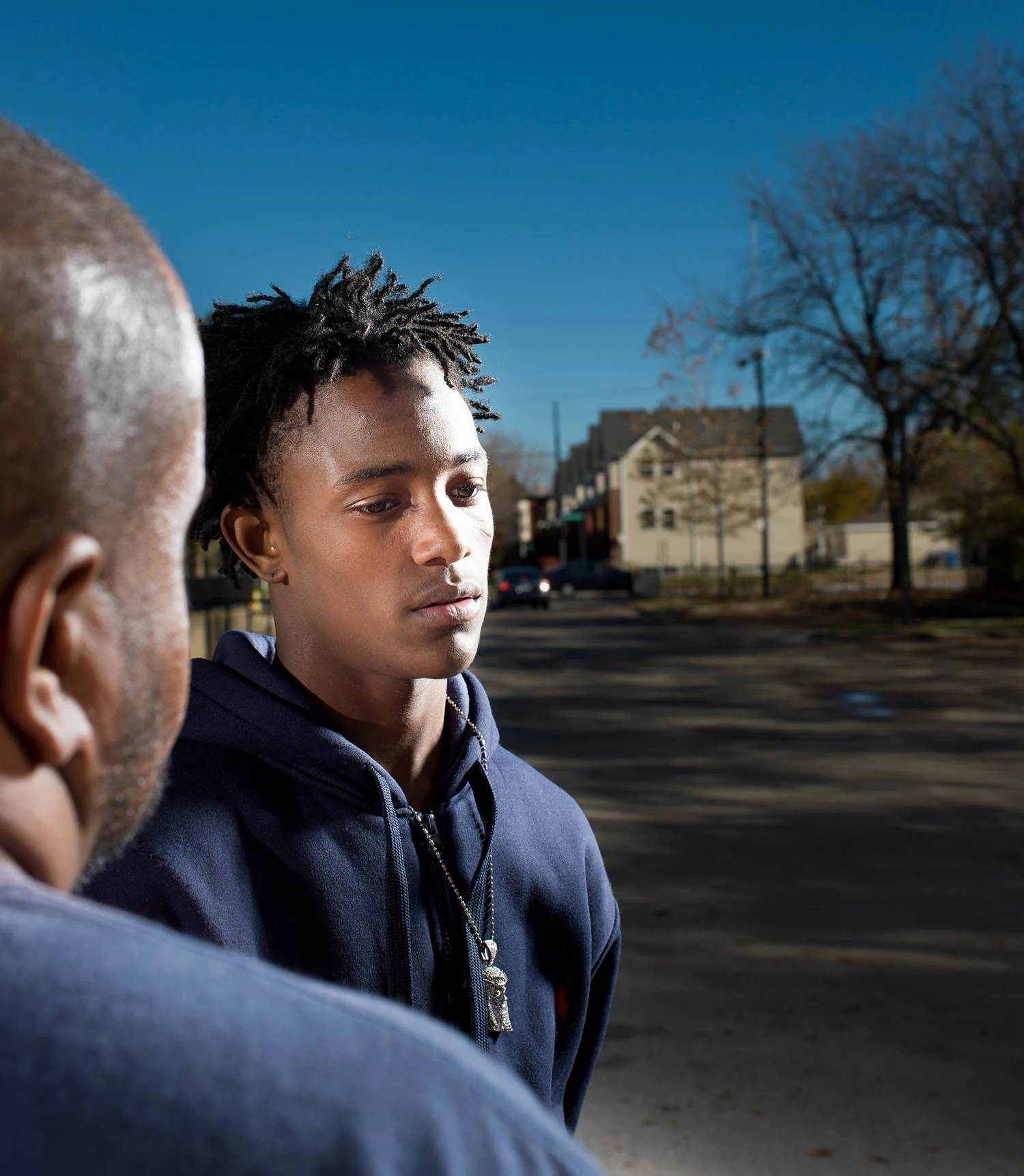 Student Jeryon Stevens outside Orr Academy with Cure Violence program coordinator Joshua Brooks.