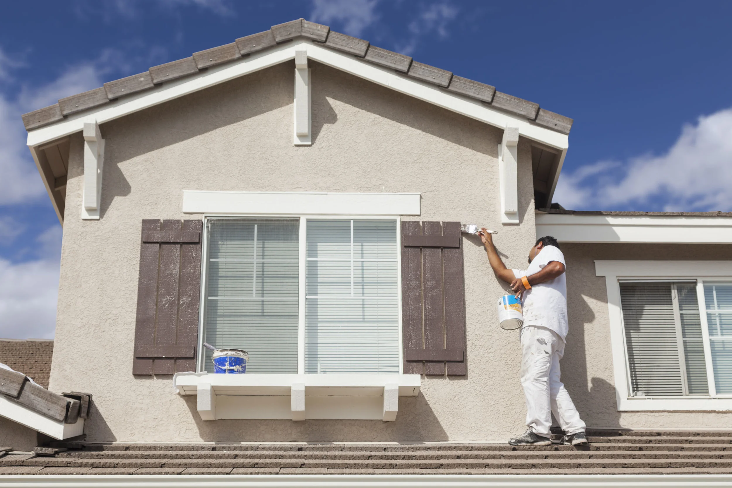 Painter on roof top Property Managers Brochure.jpg