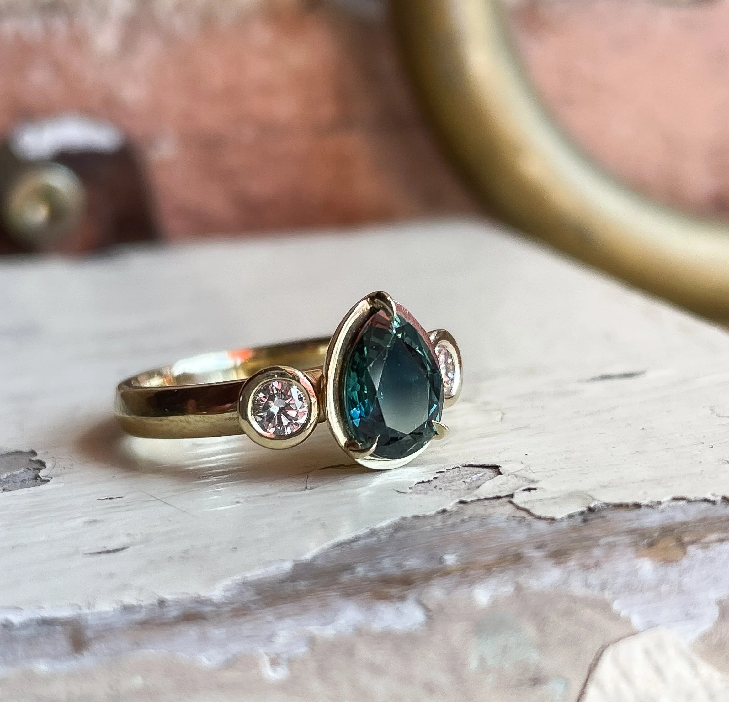sea blue sapphire with white lab diamonds in 18k yellow gold