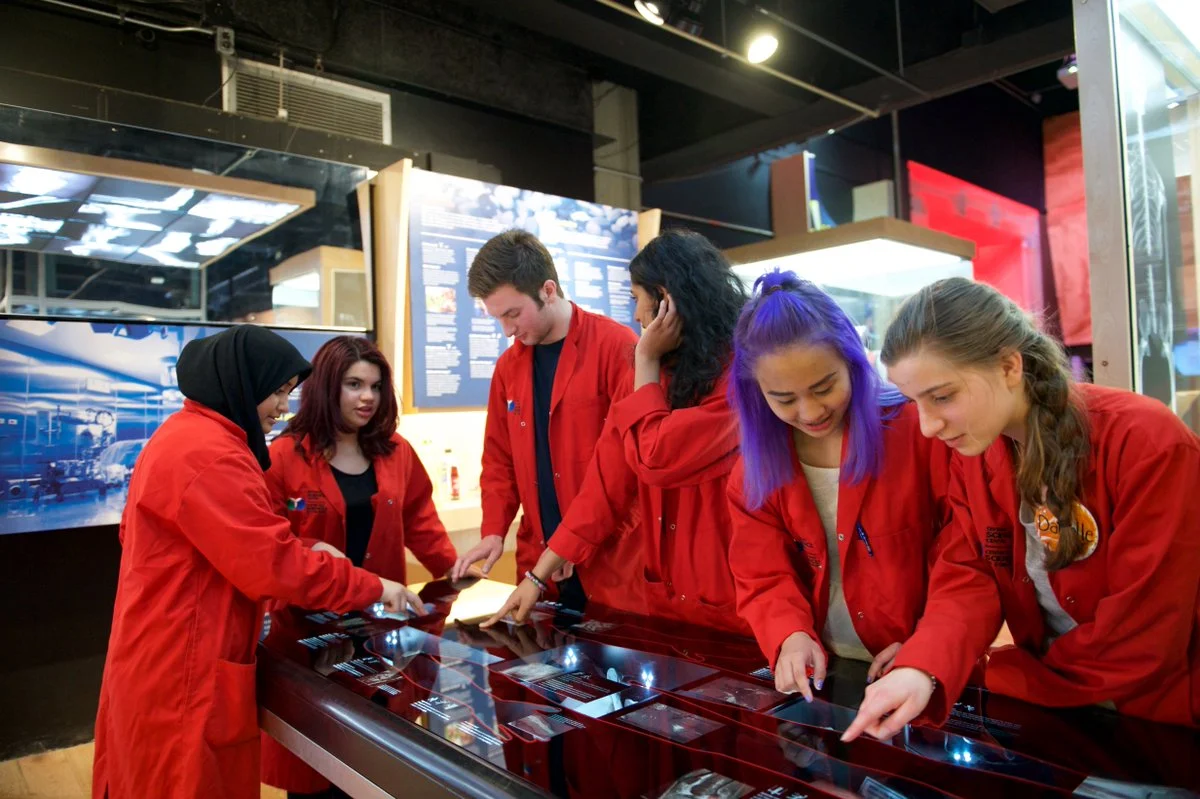 The Science School’s student Science Communicators in their distinctive red lab coats. Photo courtesy of the Ontario Science Centre .