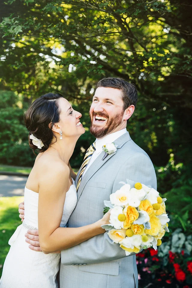 Caucasian bride and groom hugging in garden