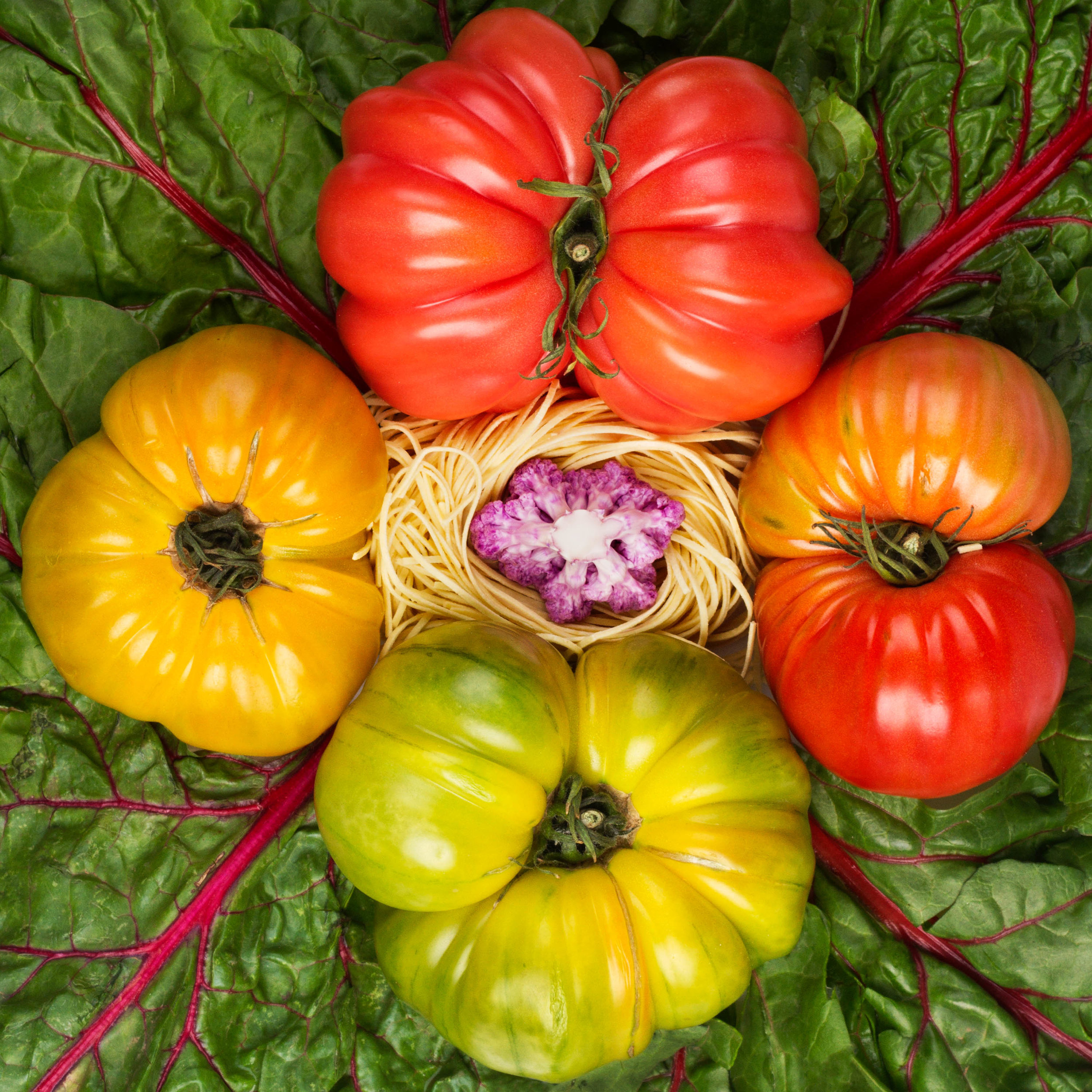  Heirloom tomatoes, al dente pasta, chard, and purple cauliflower. 