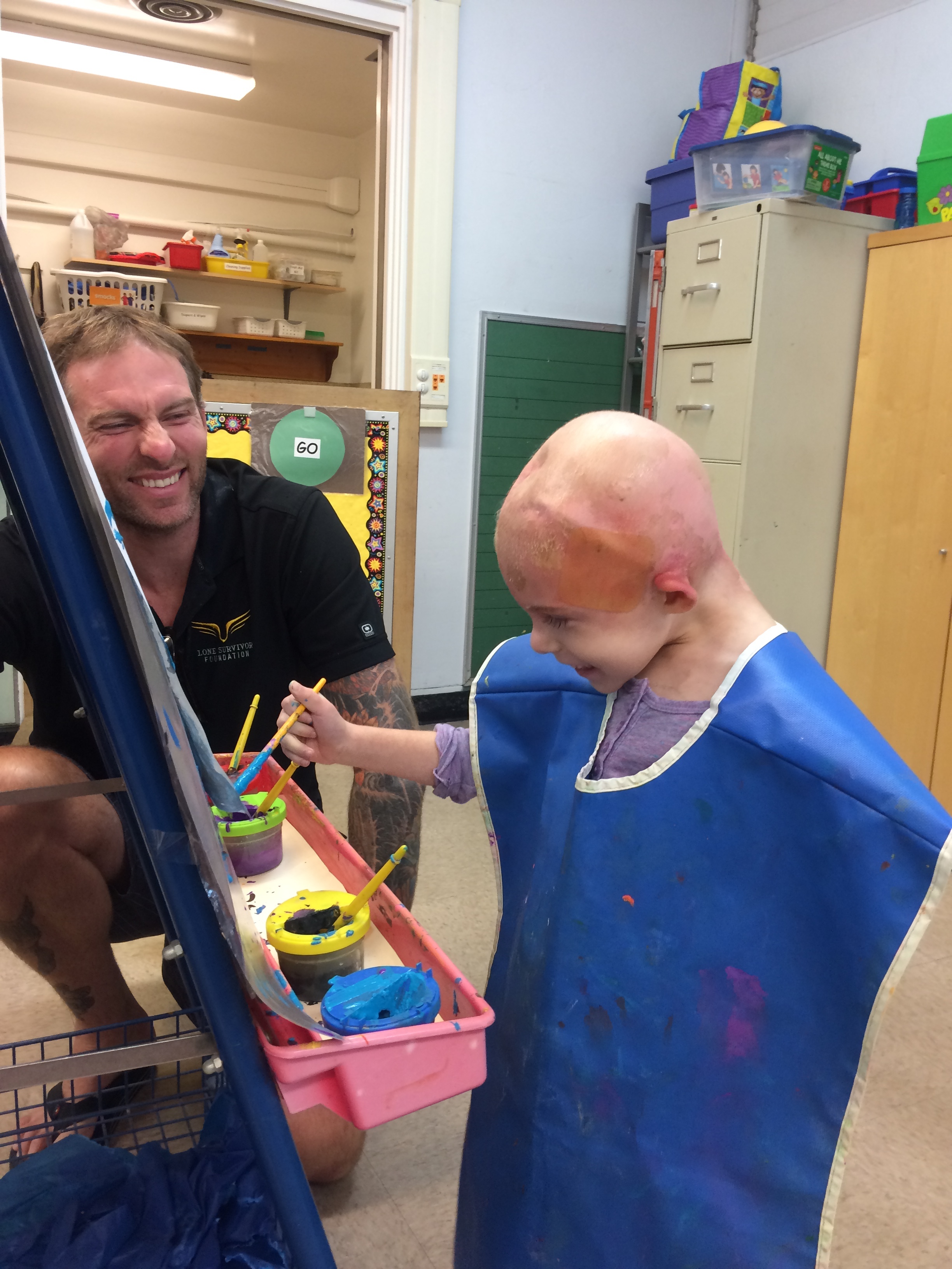 I absolutely LOVE this photo. Daddy took Amelita to her old school one day for a short visit. He was so good like that, always taking her back to Teacher Bonnie's class to make her feel connected, normal, reminding her that life existed outside the walls of a hospital or radiation room. She LOVED that classroom!!! that enormous smile!! she was so happy in this moment, just being a normal kid at school. You can see the giant MediHoney patch on the side of her head, keeping that delicately burned skin protected.