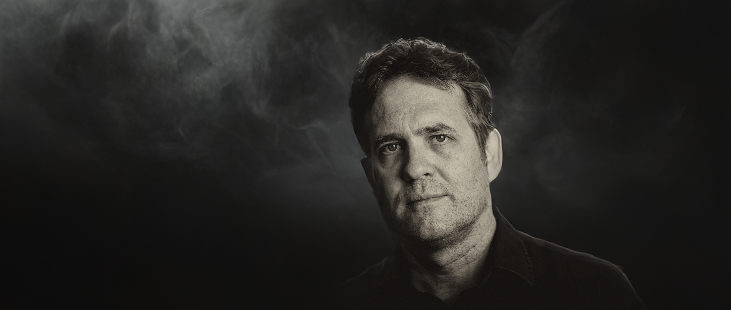 head shot smoky dark backgrond not wide.png
