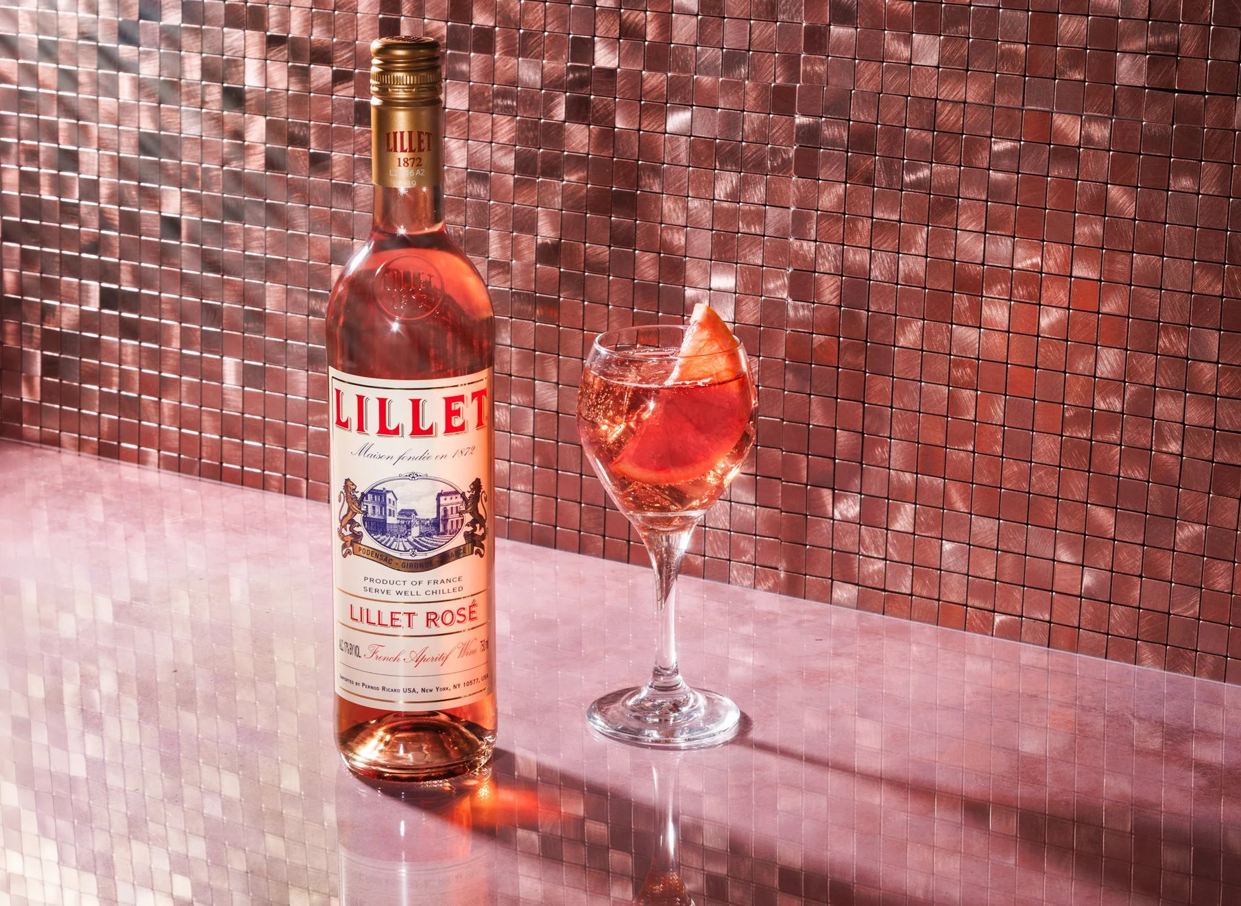 Commercial beverage product photo of rose wine bottle and glass by Amy Carson in Orange County.