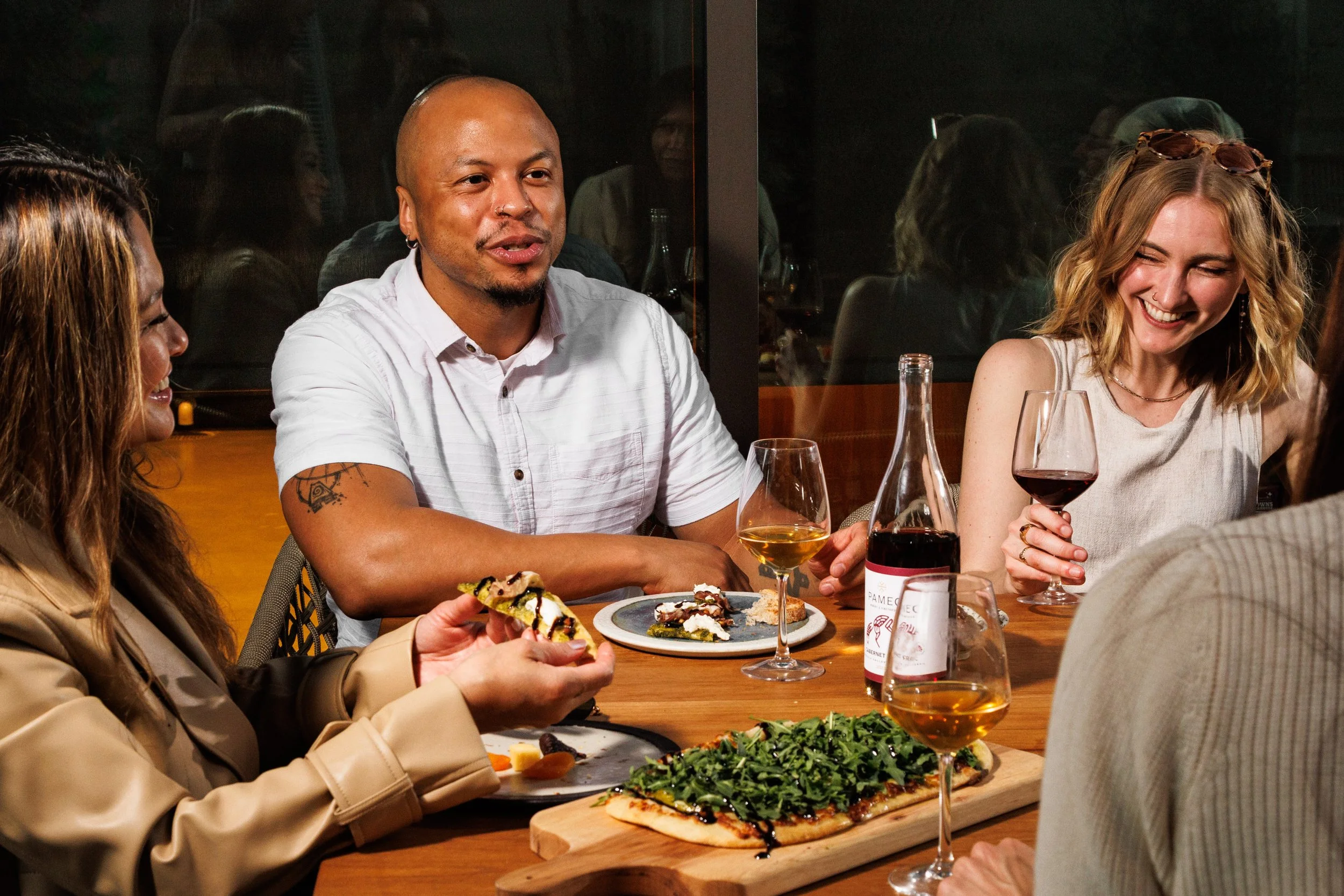 Commercial lifestyle photo of friends enjoying food & wine in San Diego. By Amy Carson.