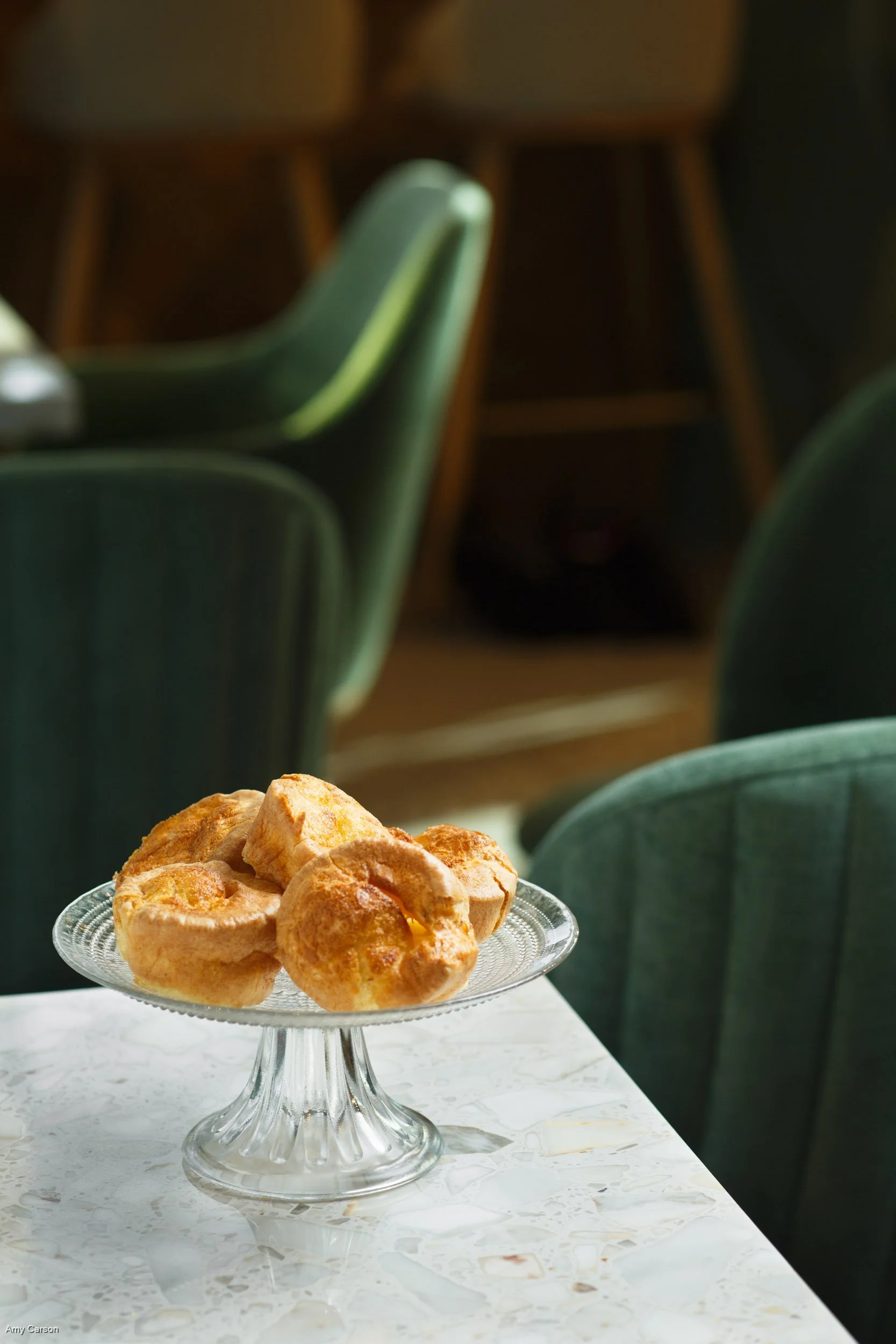  Image by Amy Carson, a San Diego food photographer. Commercial food photo of popovers in the dining room of an elegant restaurant.  