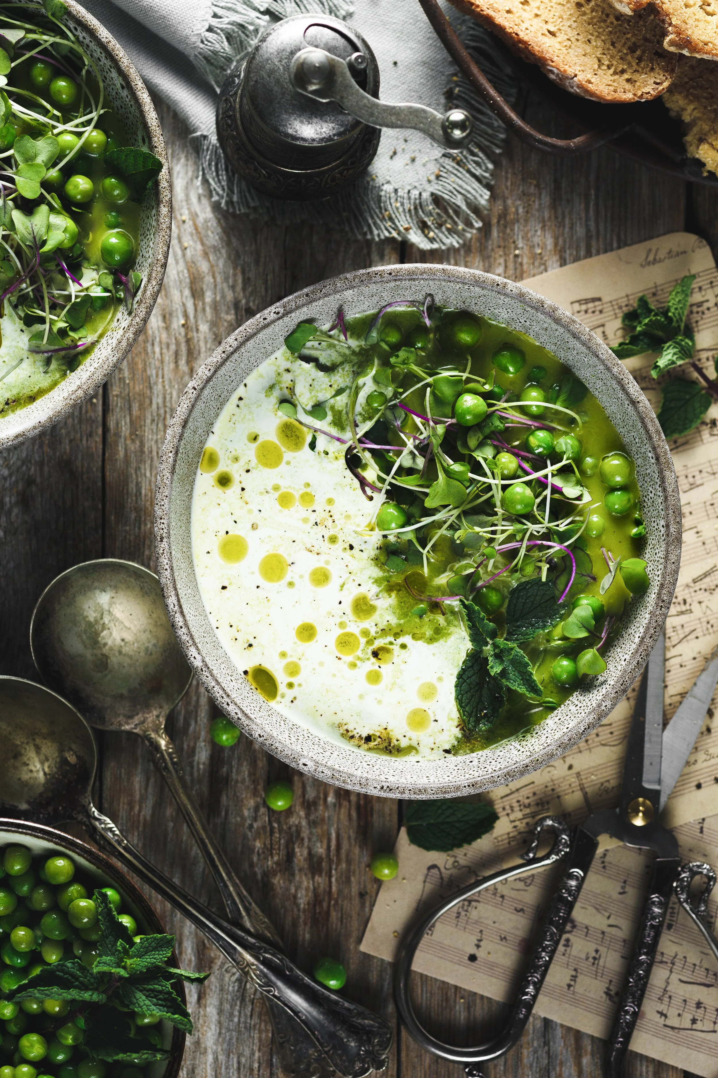  Commercial food photo of fresh pea soup with mint beautifully styled in a vintage fashion with rustic wood and scissors.  Image by Amy Carson, a food photographer in San Diego.  