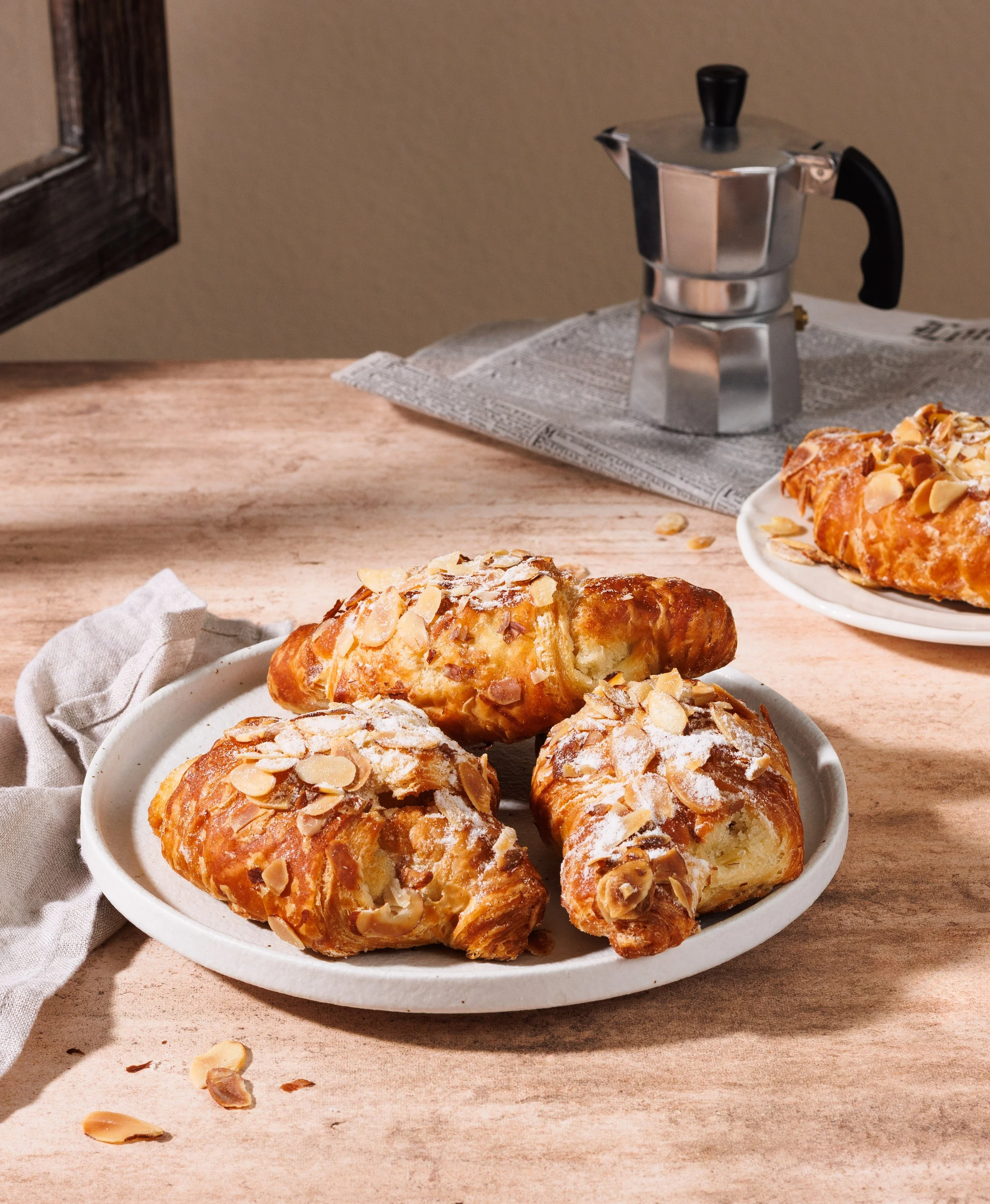  Commercial food photo of almond croissants in sunlight. By Amy Carson, commercial food &amp; lifestyle photographer in San Diego. 