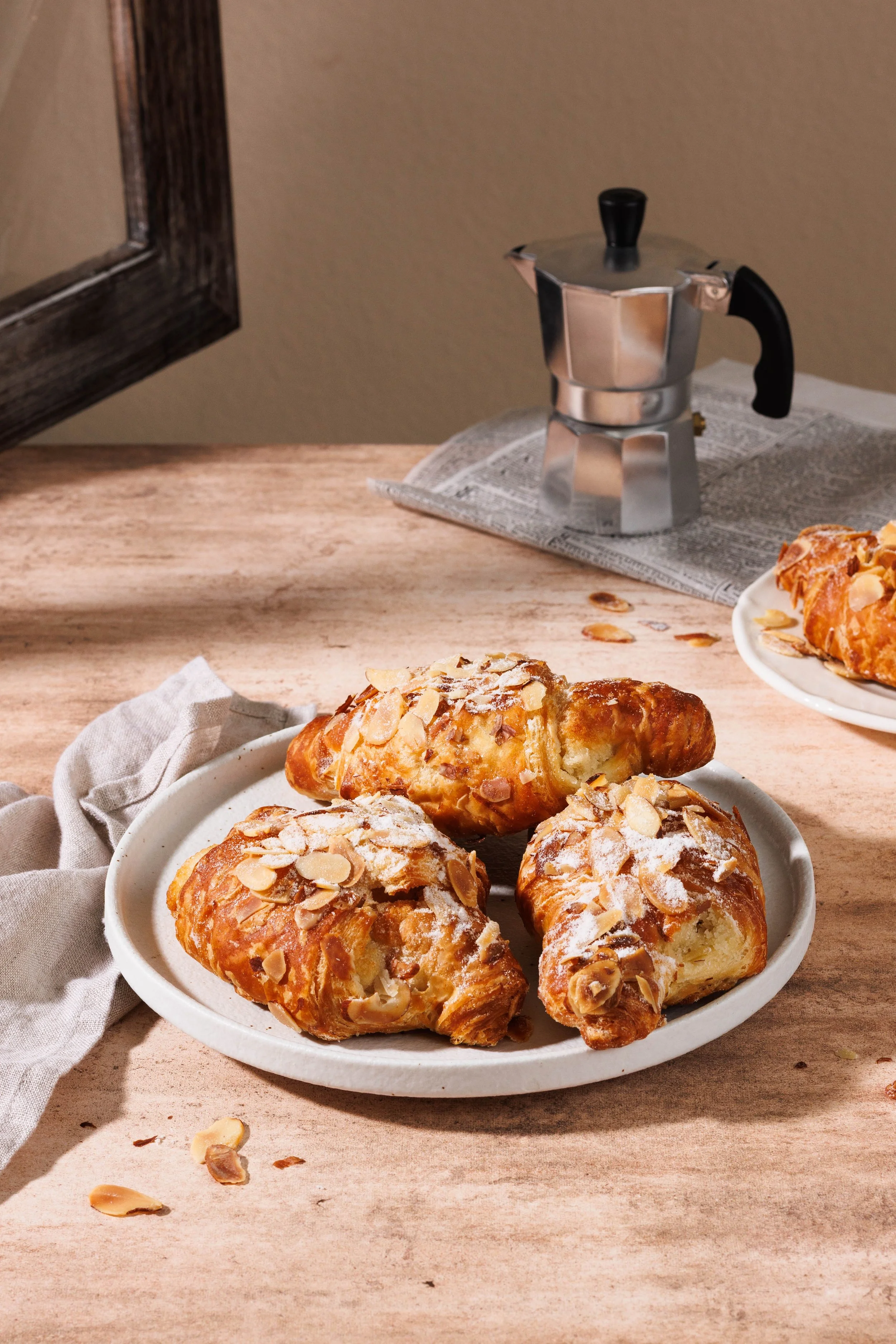  Commercial food photo of almond croissants in sunlight. By Amy Carson, commercial food &amp; lifestyle photographer in San Diego. 