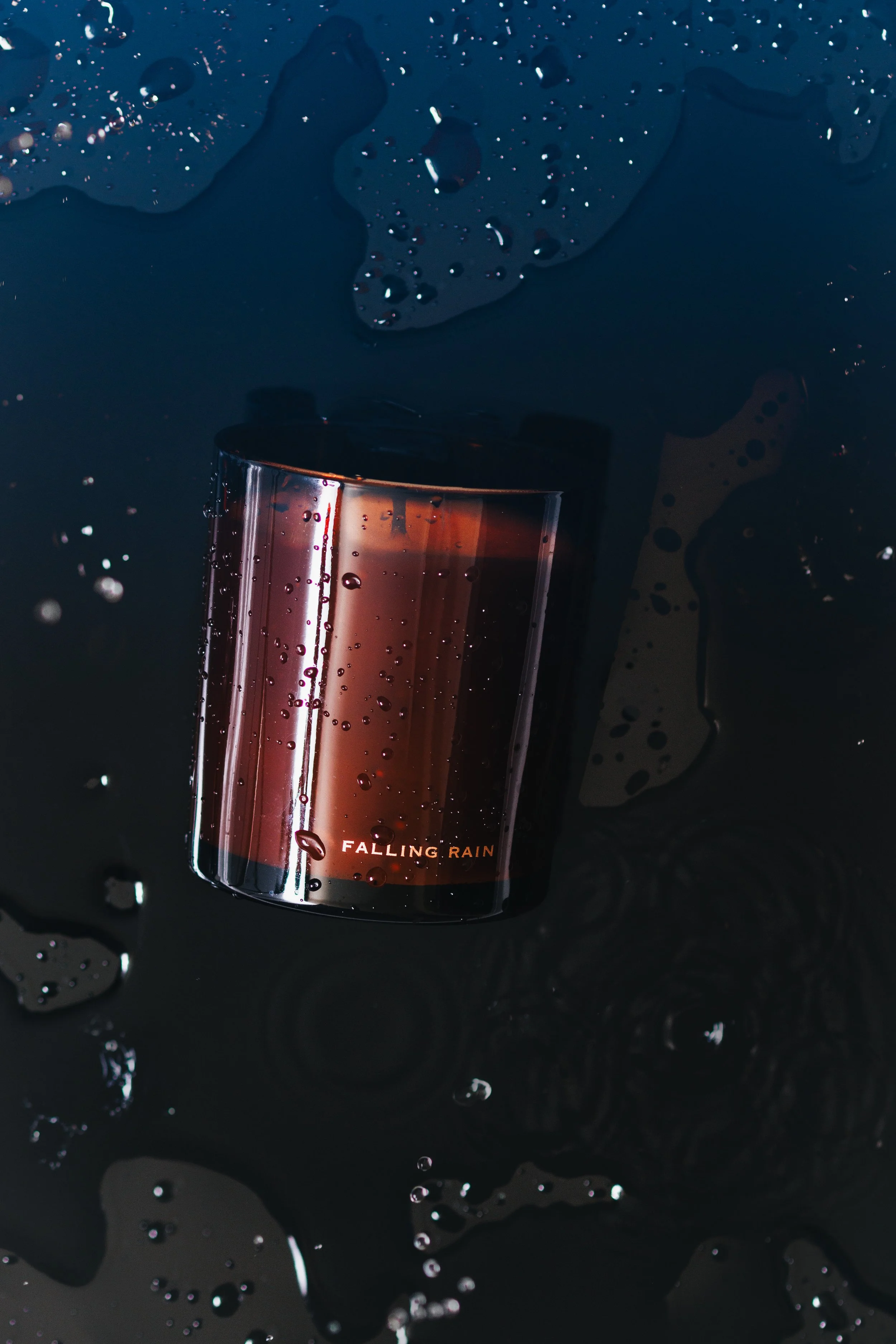 Commercial advertising photo of a candle in a puddle. Shot in a minimalist quiet luxury style.