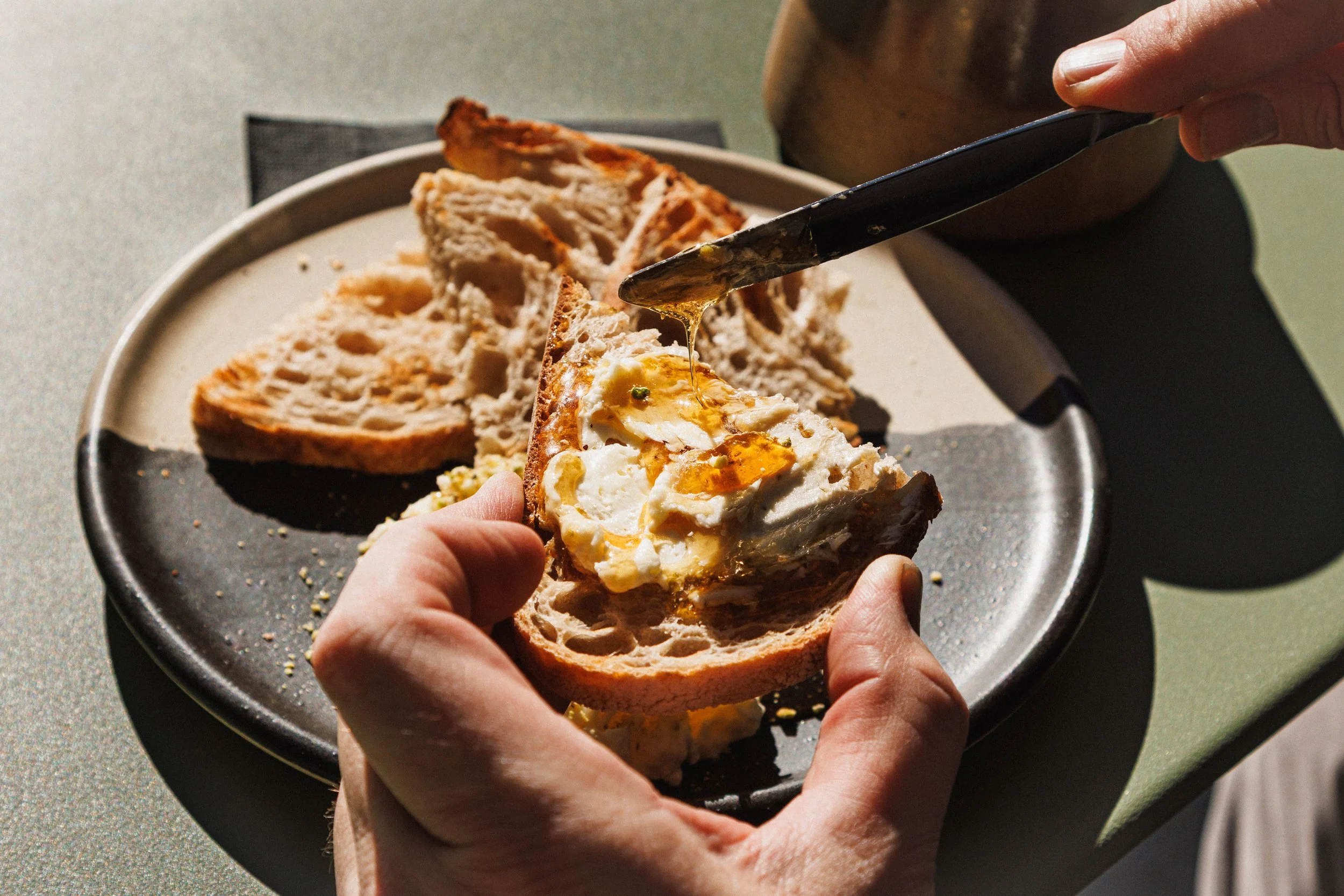 Commercial food photo of butter and honey on bread shot in San Diego.