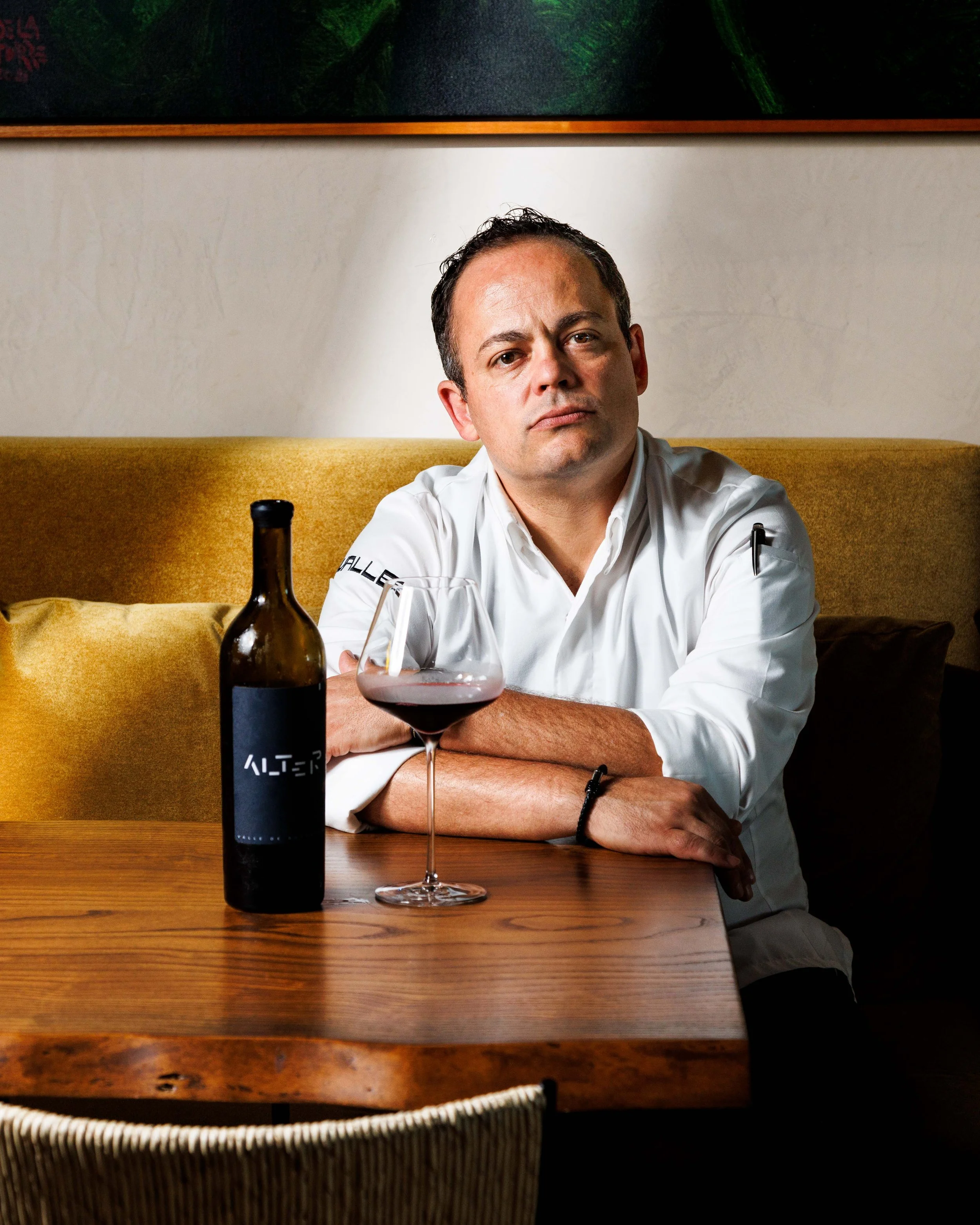  Editorial portrait of a chef drinking wine in his fine dining restaurant. Shot for the Los Angeles Times by San Diego food photographer Amy Carson. 