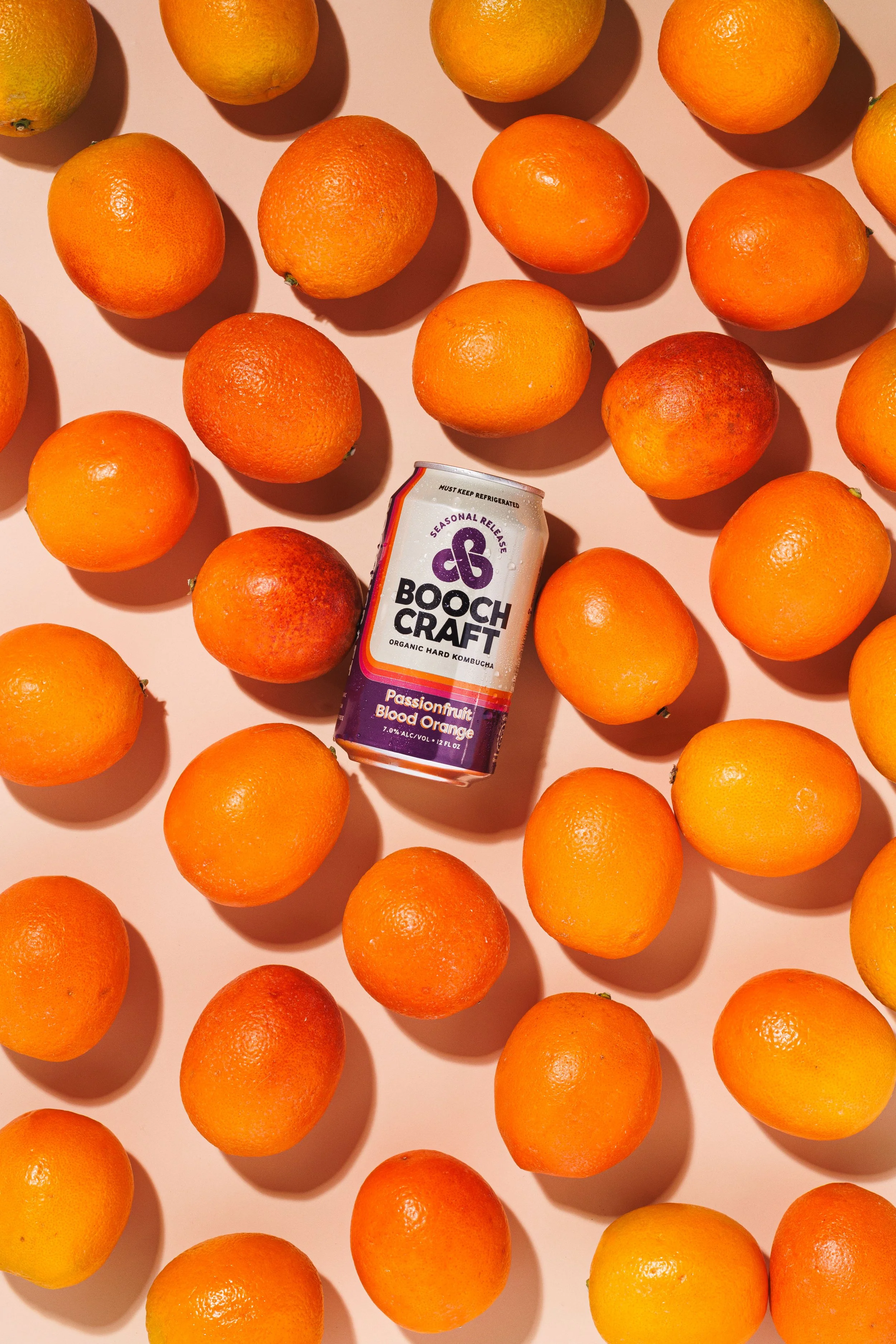 Commercial product photo of a canned beverage with oranges around. By San Diego lifestyle product photographer Amy Carson.