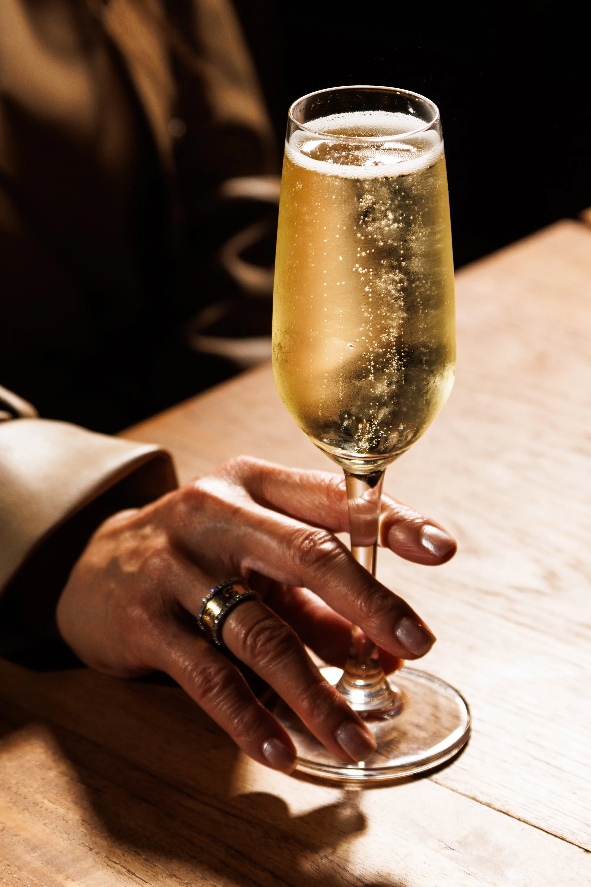 Commercial lifestyle beverage photo of a sparkling glass of champagne.