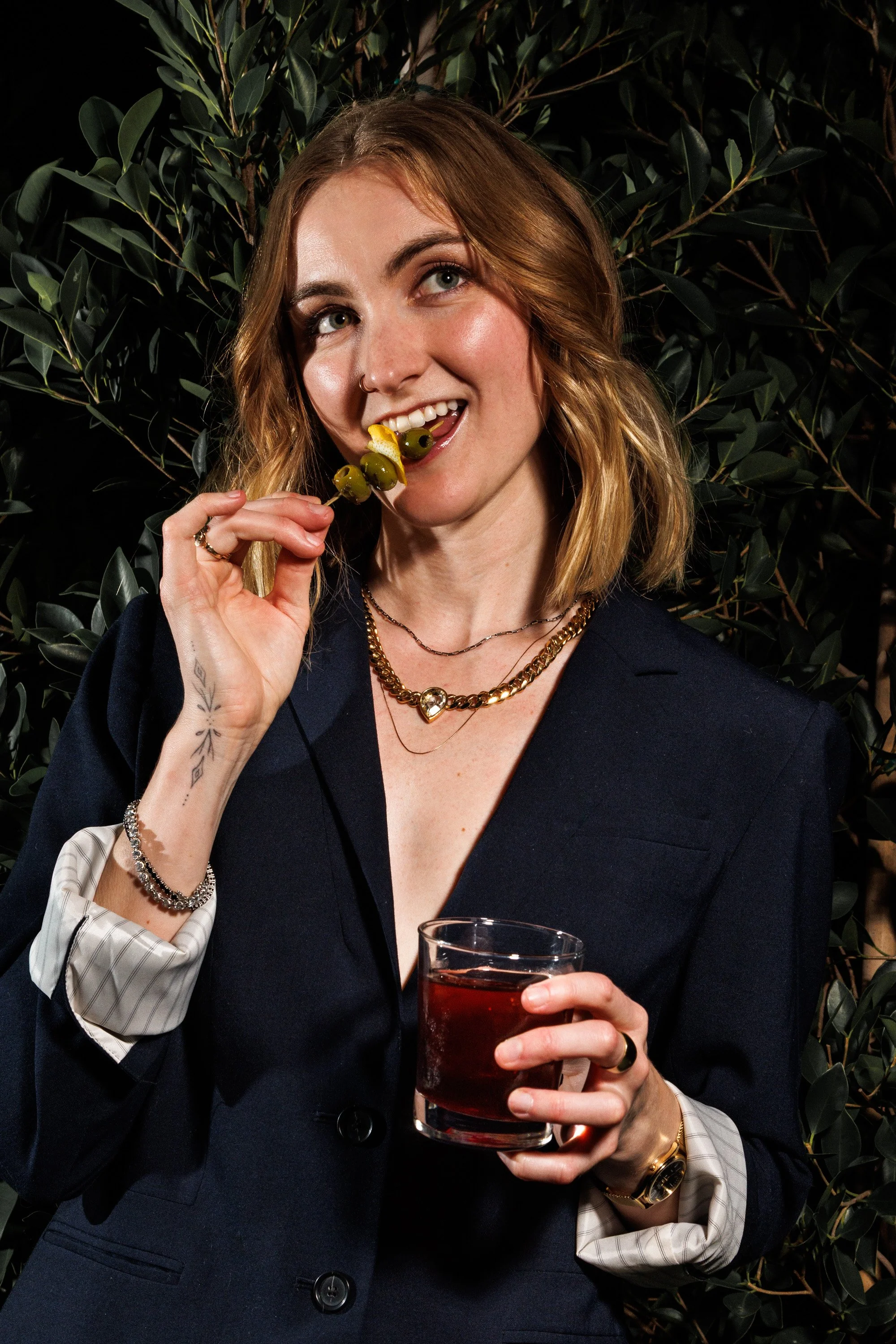 Commercial beverage lifestyle photo of a girl posing with a cocktail.