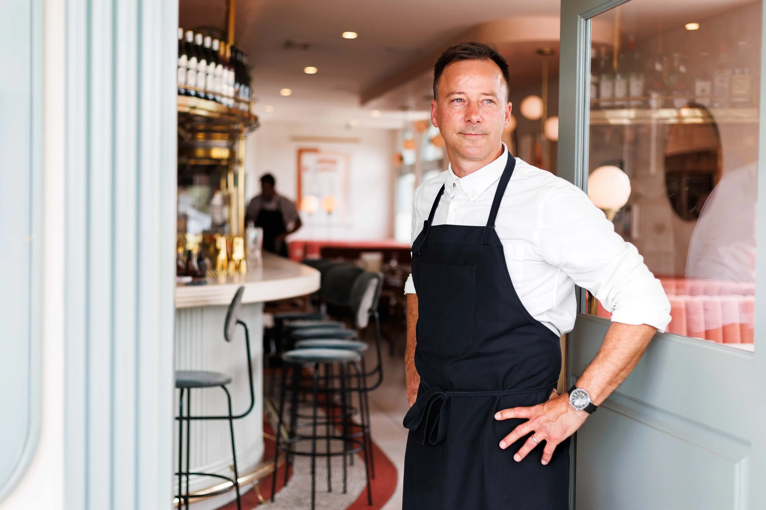  Editorial photo of chef greeting fine dining guests in Michelin Star restaurant in Carlsbad, California. Shot for the Los Angles Times by San Diego food photographer Amy Carson. 