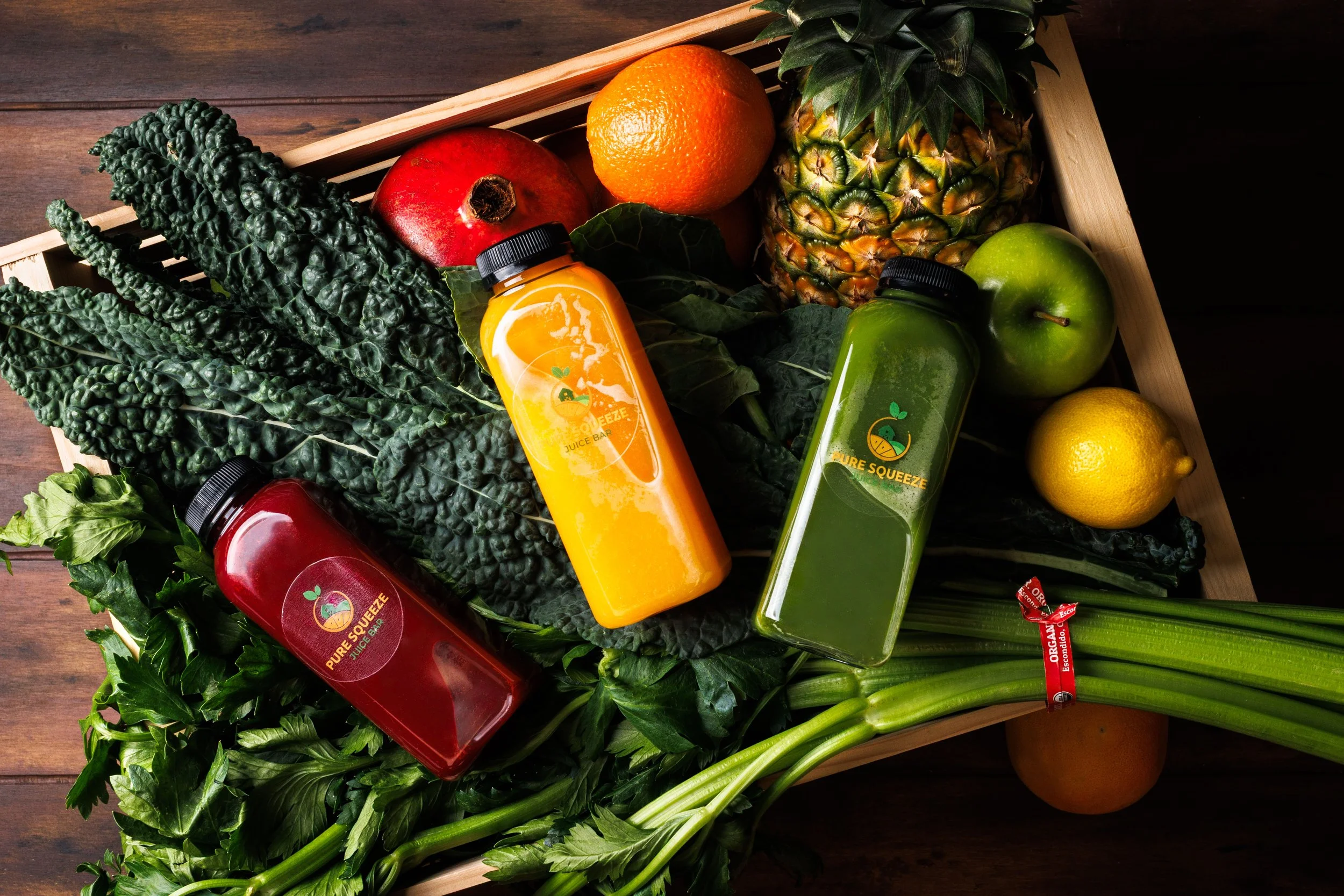 Commercial product photo of juice bottles in an earthy style. By lifestyle product photographer Amy Carson.