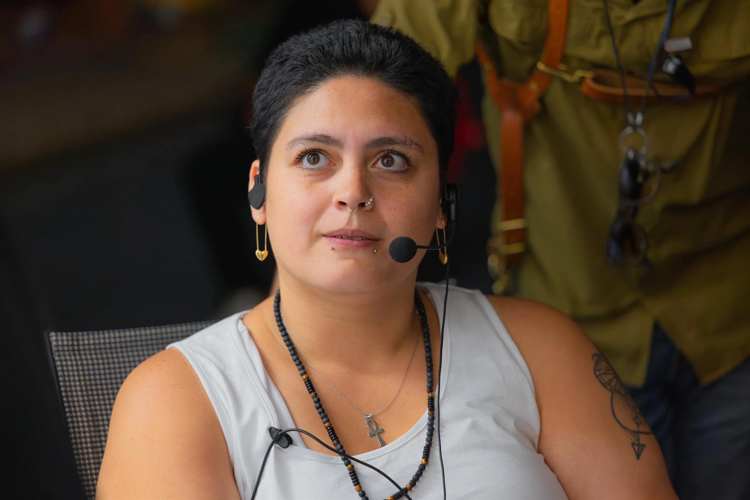 Ahlan Simsim unit still: A production crew member wearing a headset looks upward while working on set.