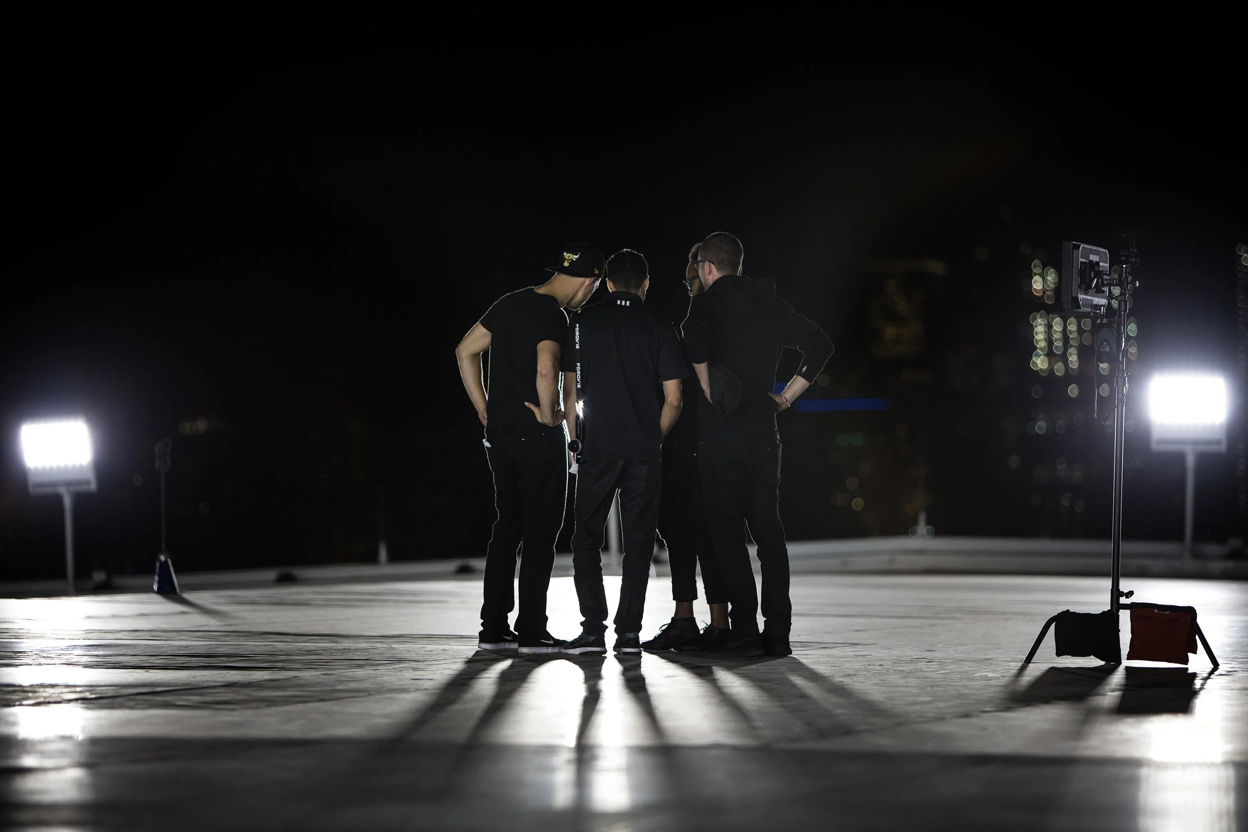 Behind the Scene Photograph by Chicago set photographer Rashad Anabtawi of the Director, Cinematographer, and Drone Operator reviewing the footage