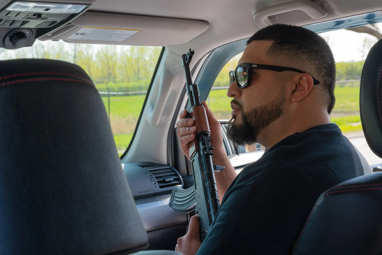 production Still by Chicago Set Photographer Rashad Anabtawi of the Talent with prop Weapons