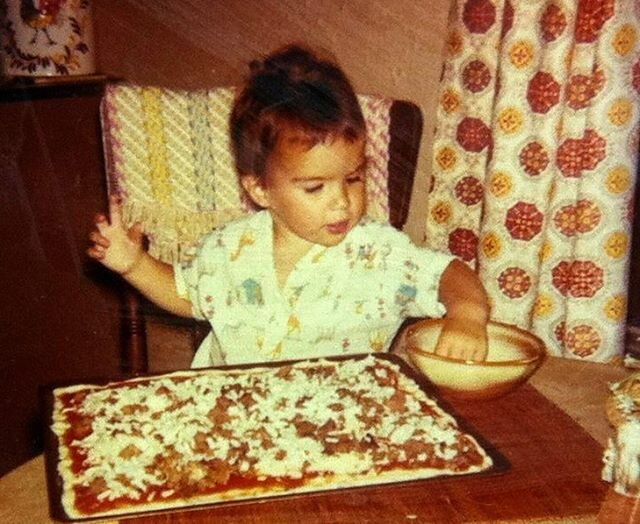 Little me putting cheese on a pizza. I distinctly remember doing this, and I realized the importance of even cheese coverage. 🧀