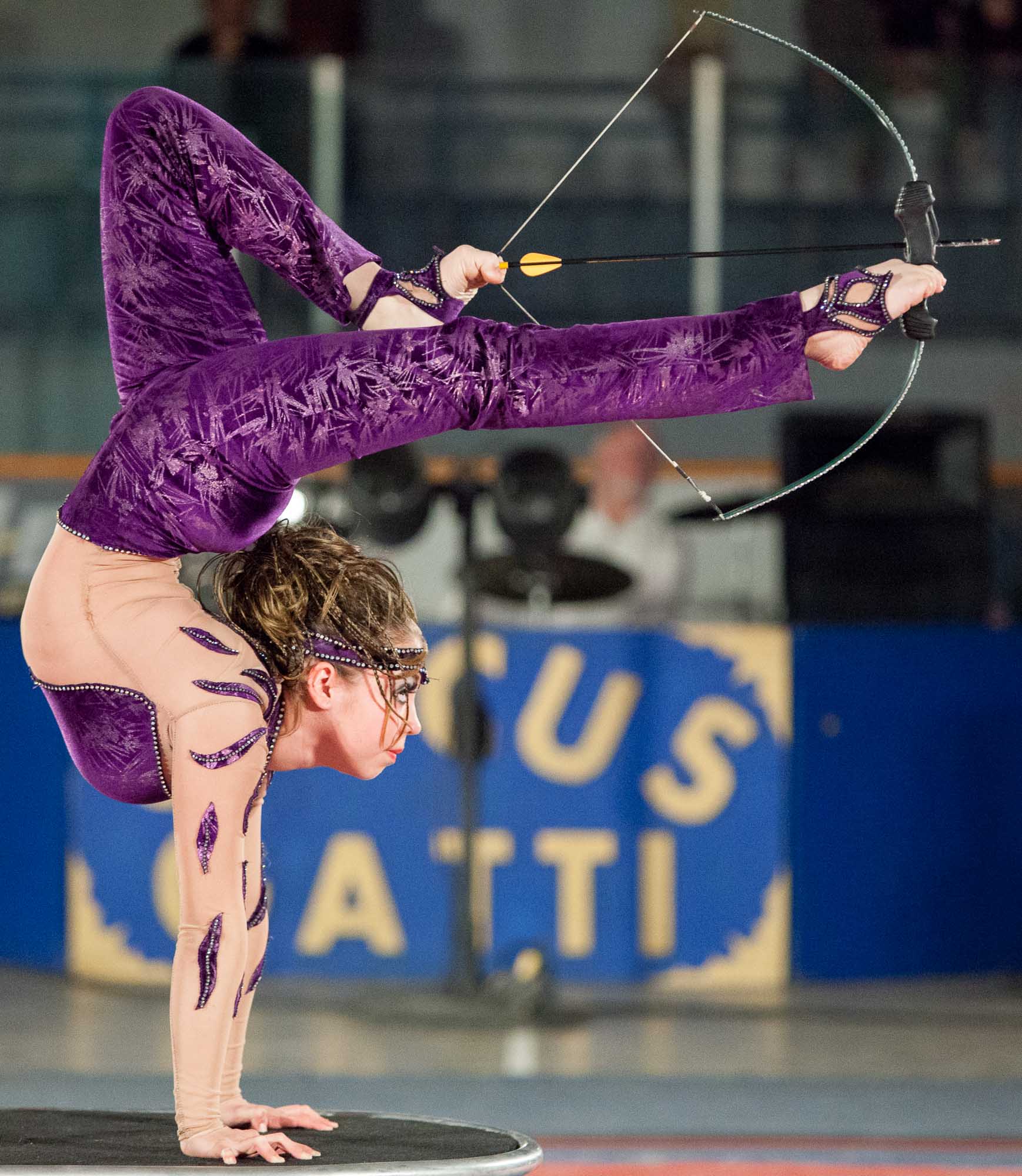 A Circus Gatti performer shoots a bow and arrow at a balloon using only her feet during the circus’s performance at the Didsbury Memorial Arena in Didsbury, Alta. on May 19, 2011.
