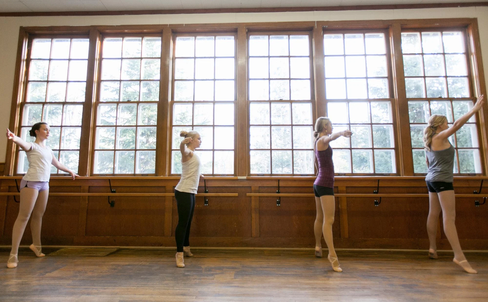 From left, Move Yourself Dance students Codi Wilson, Julia Helland, Bailey Sommerfeld and Alisa Brace do pointe work at the barre at the group’s studio in Sundre, Alta. on Oct. 7, 2014.