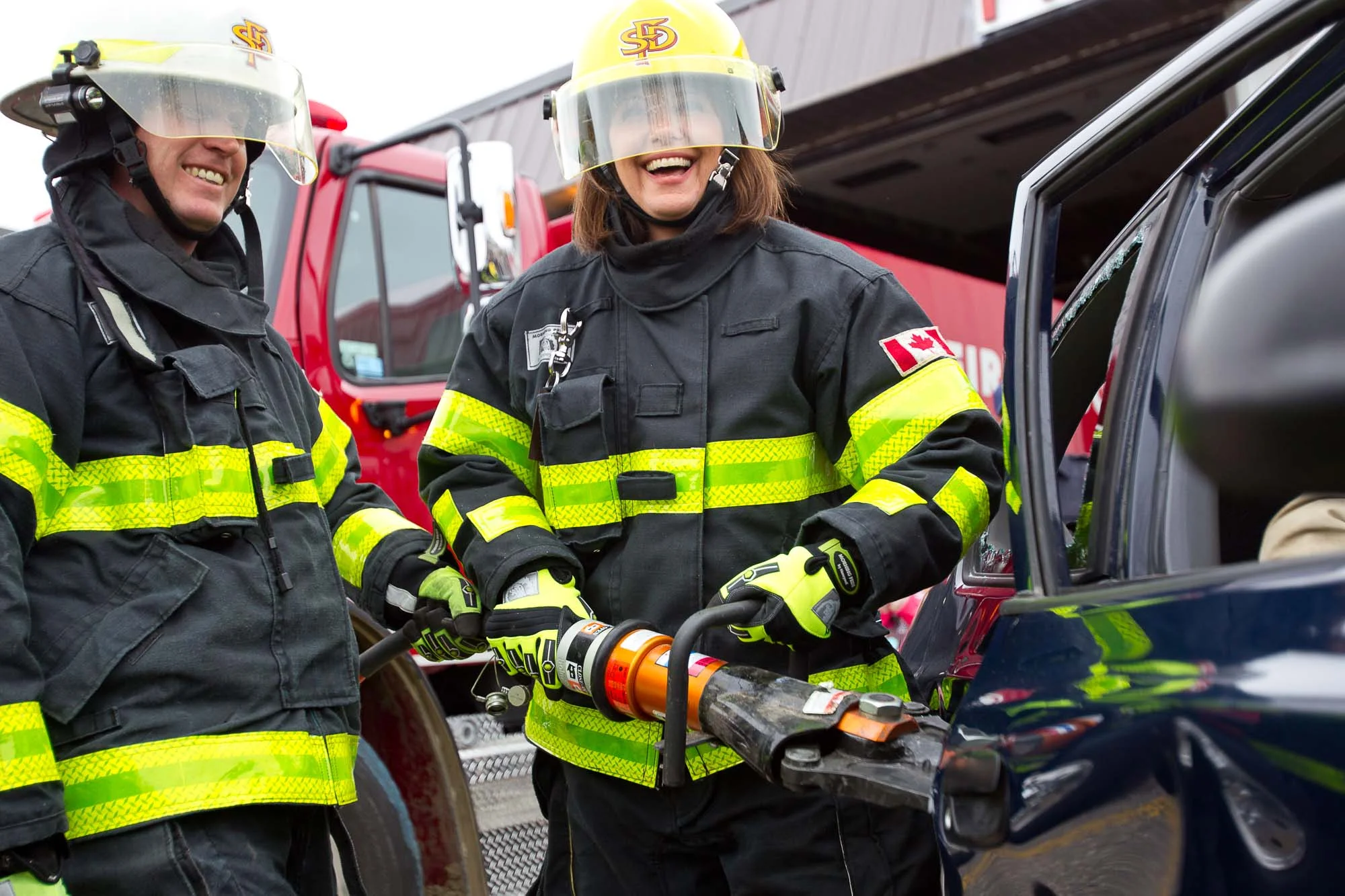 Wildrose Leader Danielle Smith, right, shares a laugh with Sundre fire chief Marty Butts during a vehicle extrication demonstration in Sundre, Alta. on Apr. 14, 2012.